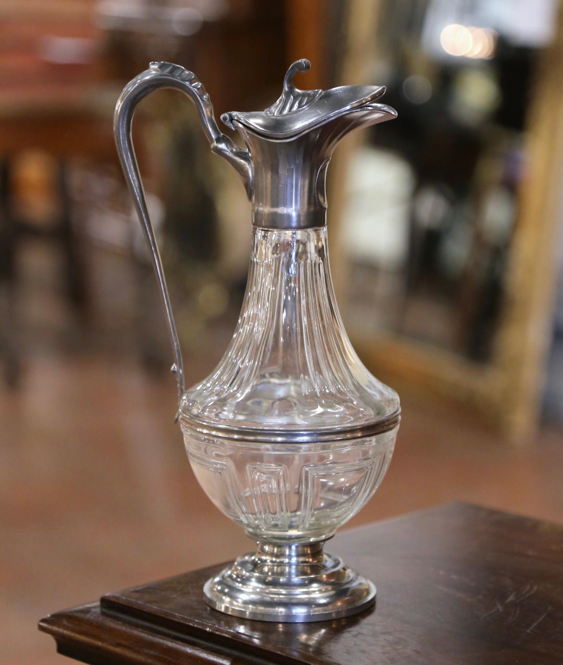 Sirve tu Burdeos o Cabernet Sauvignon favorito con estilo en este elegante decantador antiguo. Fabricada en Francia hacia 1950, la jarra de cristal tallado con decoración geométrica se alza sobre una base circular de estaño. El cuello alto con gran