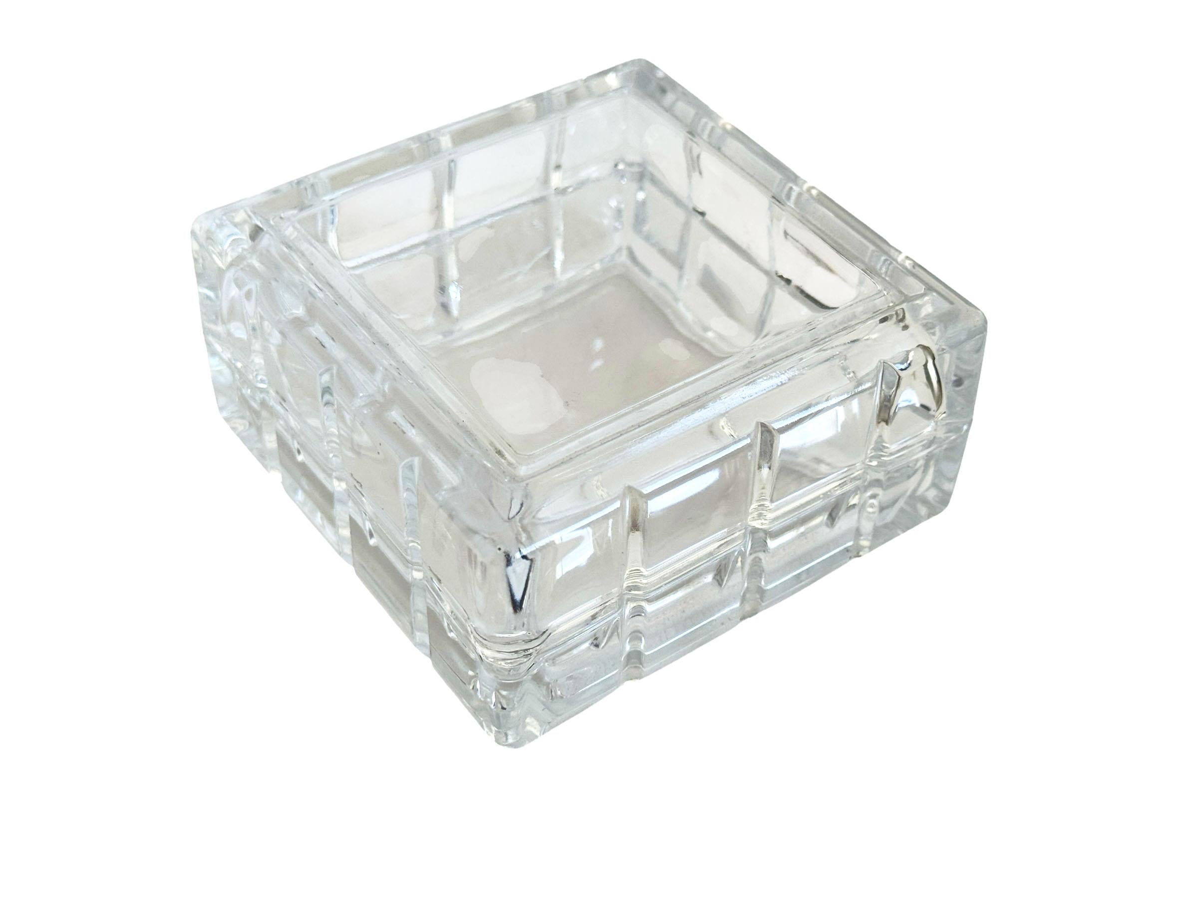 An exquisite mid century crystal box showcases a sleek, contemporary design that balances form and function. Crafted in France during the 1980s, the box features two pieces that fit seamlessly together to create a flawless square when closed.