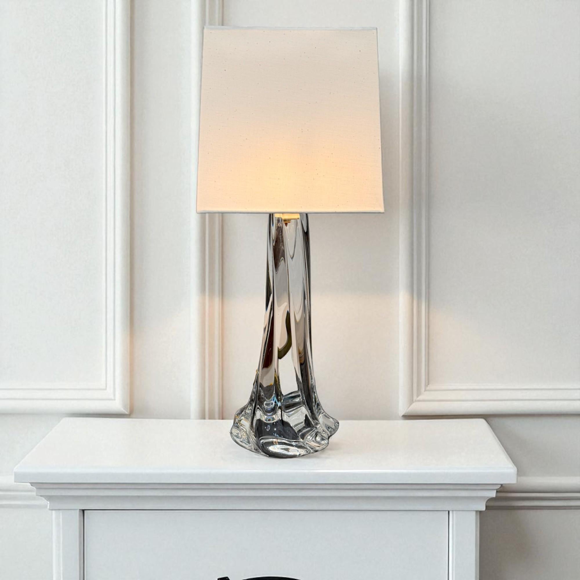 Table lamp by Daum, one of France’s most celebrated glassmakers, renowned for its artistry and refinement since 1878. This exceptional piece, dating from the mid-20th century, showcases the house’s signature mastery of crystal, blending technical
