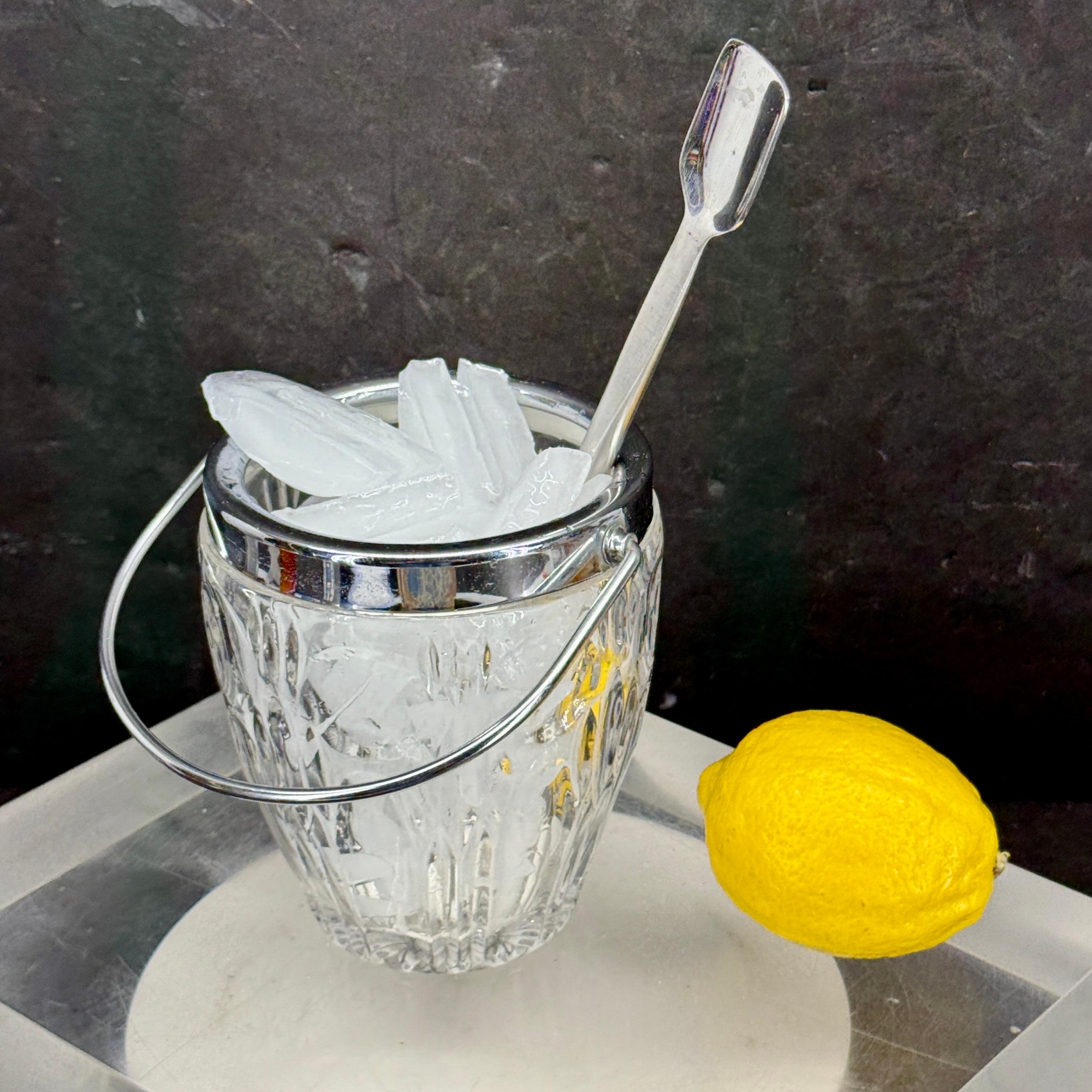 As found in a Paris market, a charming small Mid-Century Modern glass ice bucket. This ice bucket is both beautiful and functional. The plating is around the top of bucket as well as handle. Fantastic classic piece to add to your modern bar.