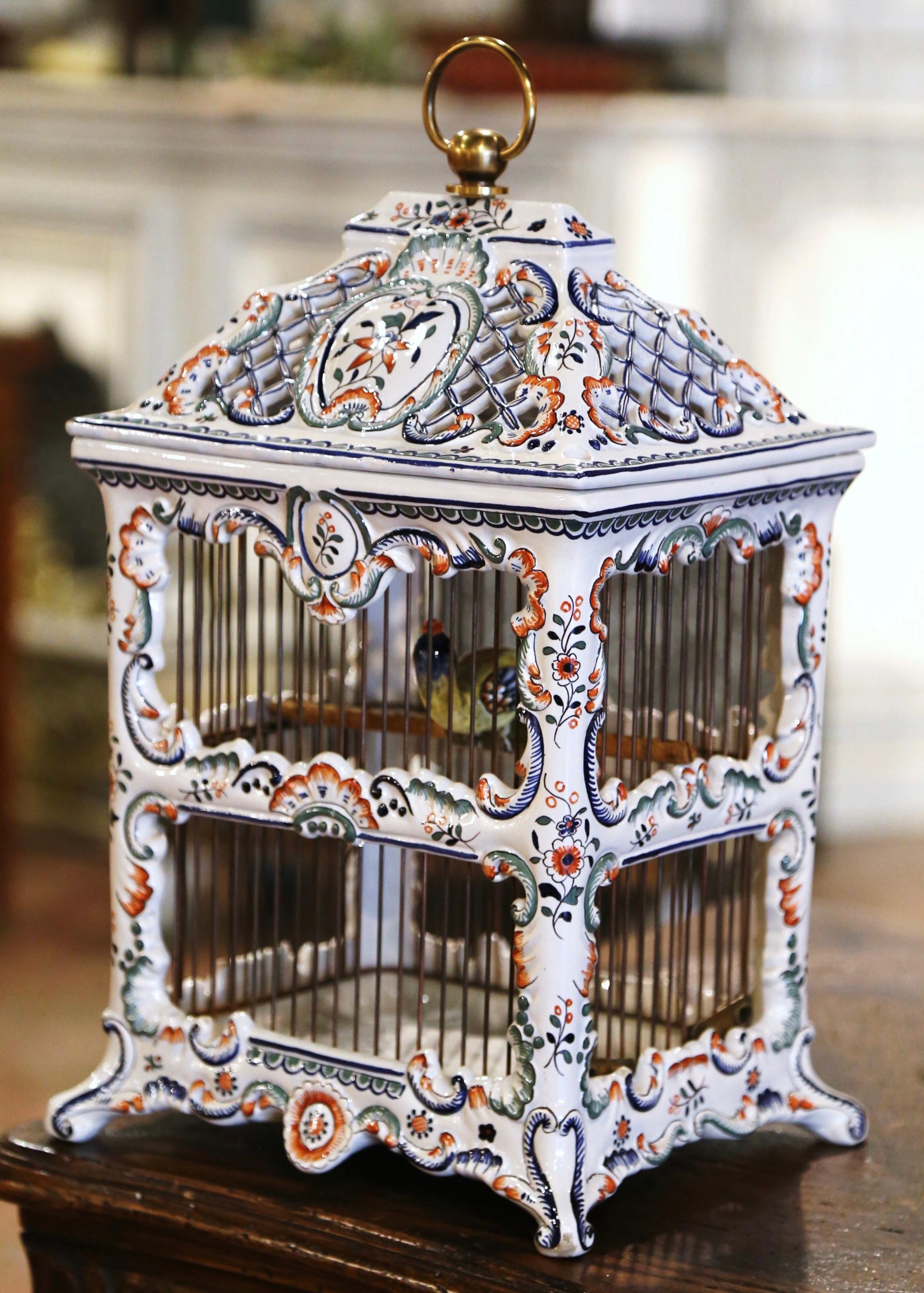 This beautiful, feminine decorative porcelain birdcage would make a lovely addition to a woman's office or study. Crafted in Rouen, Normandy circa 1950, and built of faience, the cage stands on scroll feet over a scalloped apron decorated with