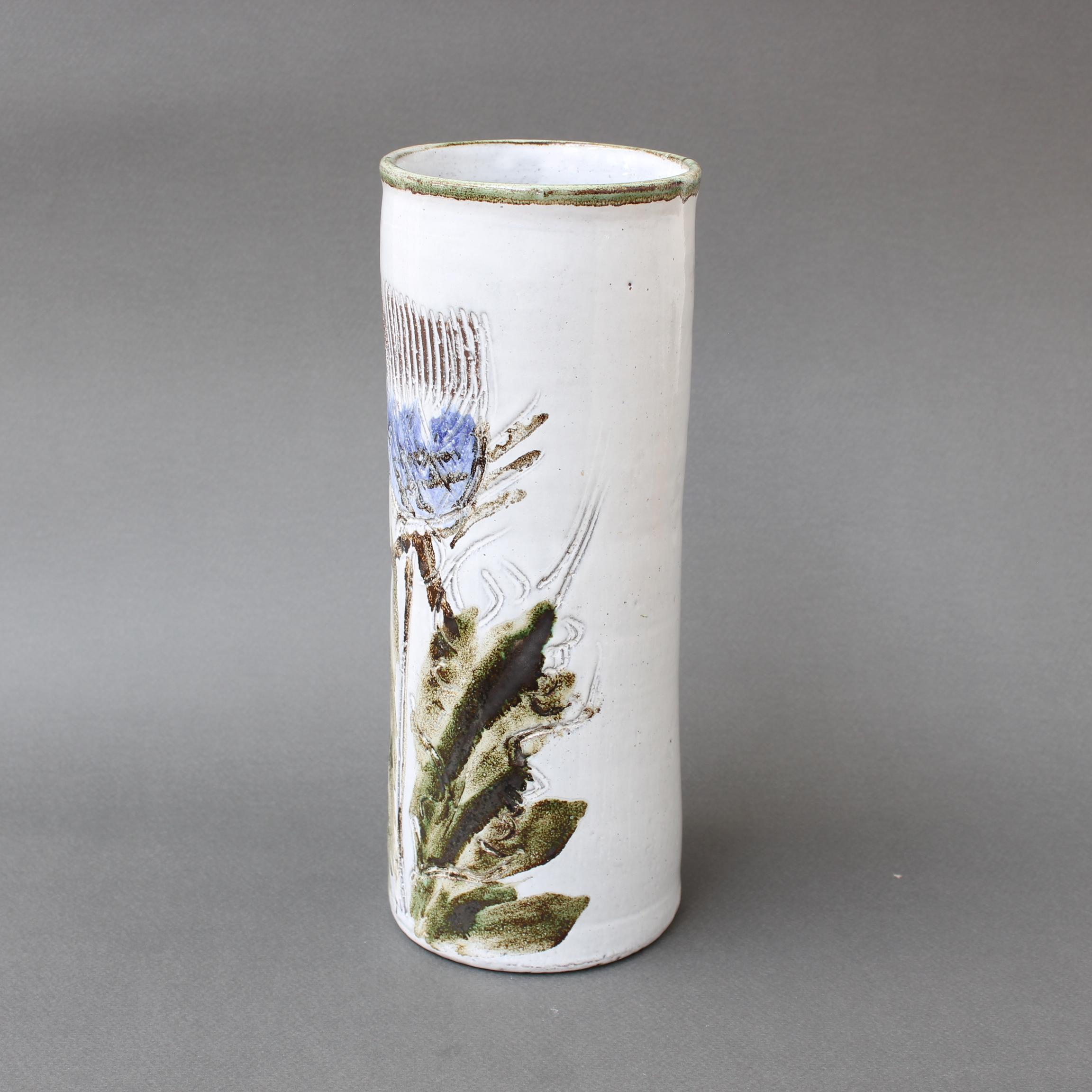 Mid-century decorative vase by Albert Thiry (circa 1960s). A gentle creamy-white glaze encompasses the exterior of the vase and is topped at the lip by a soft sage green. Covering the piece you will find a large stunning, blue flower - probably a