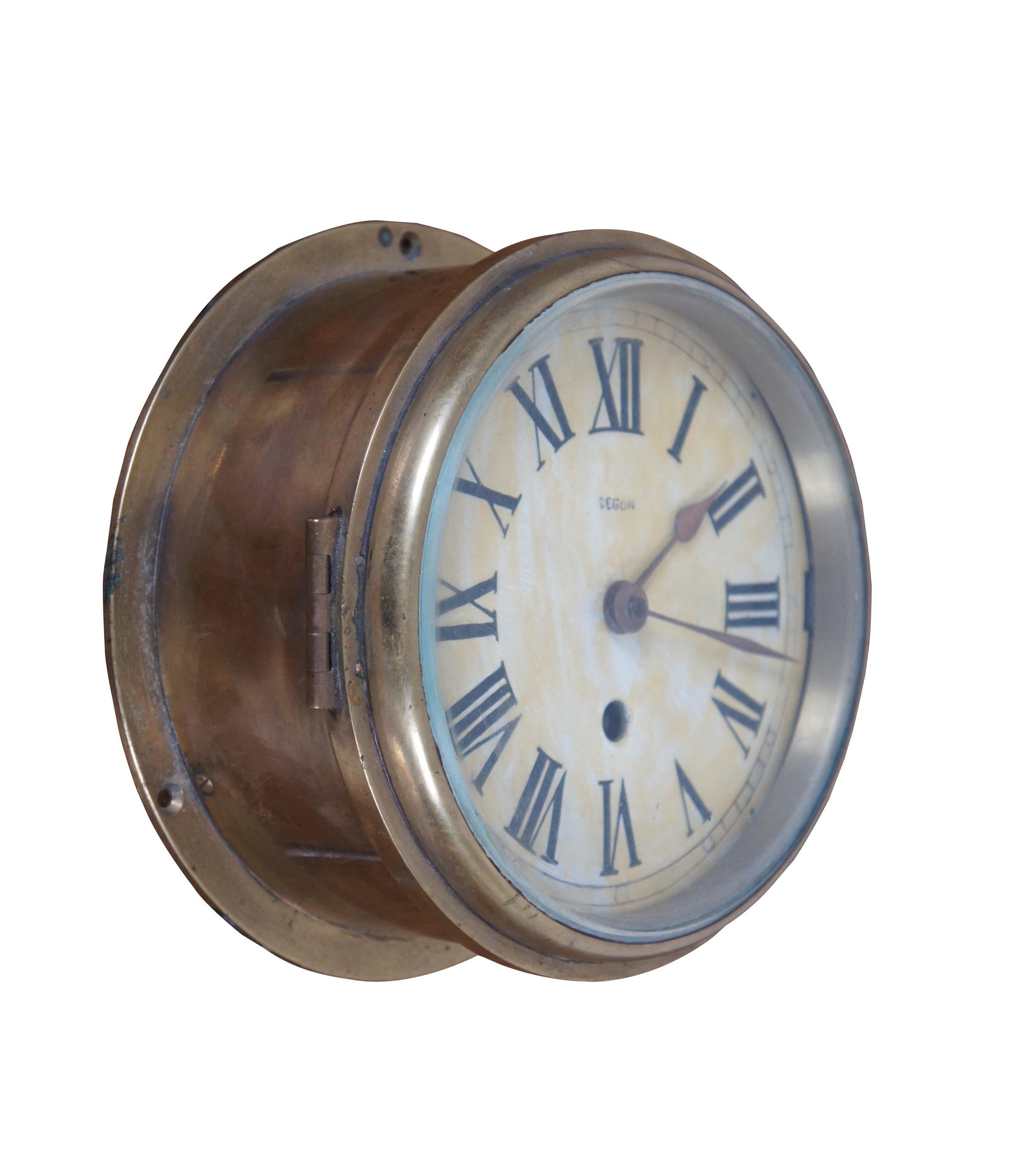 Orologio da nave francese Degon Rouen della metà del secolo scorso. Cassa in ottone montata a muro con quadrante dipinto, numeri romani, lancette in rame, con vetro spesso. Opere numerate 6 56 005042.  Prodotto in Francia nel 1956