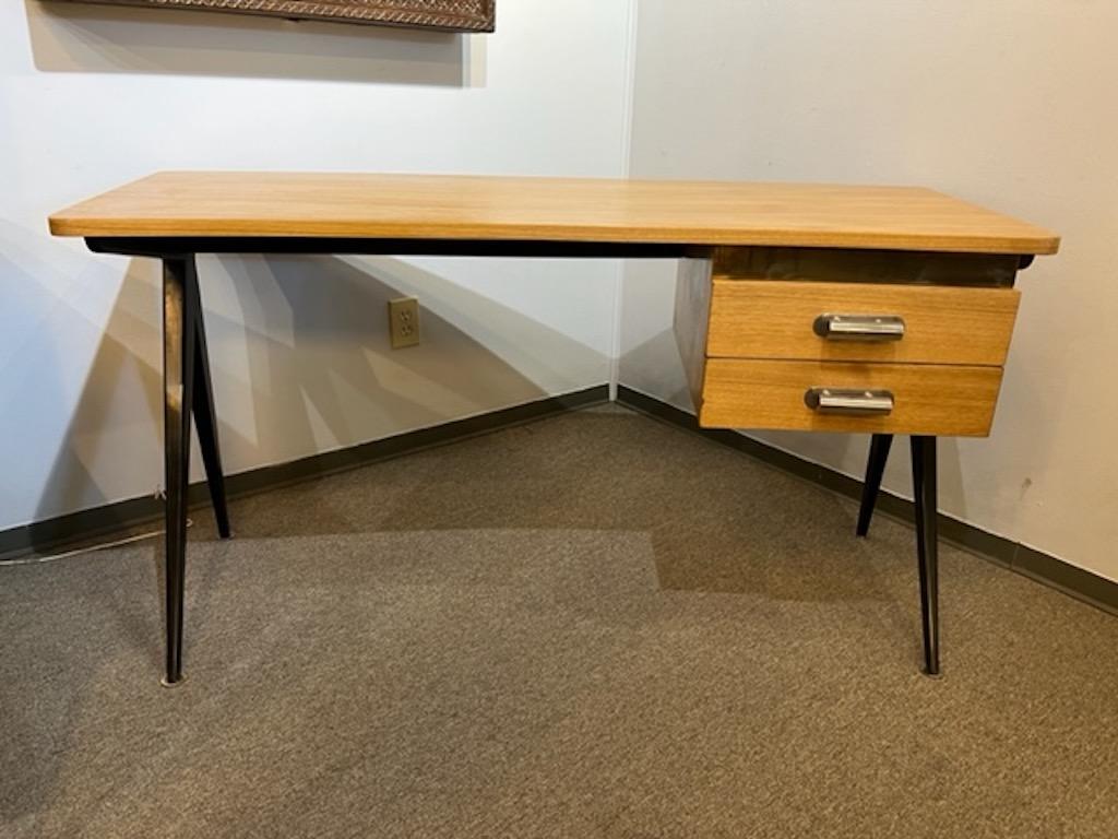 Desk is created out of walnut wood with light polish, 4 elongated legs are ebonized, which presents juxtaposition between light and dark colors of the wood. Desk has 2 spacious drawers with chrome handles. 

Condition is perfect, restored
French,