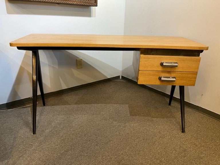Desk is created out of walnut wood with light polish, 4 elongated legs are ebonized, which presents juxtaposition between light and dark colors of the wood. Desk has 2 spacious drawers with chrome handles. 

Condition is perfect, restored
French,