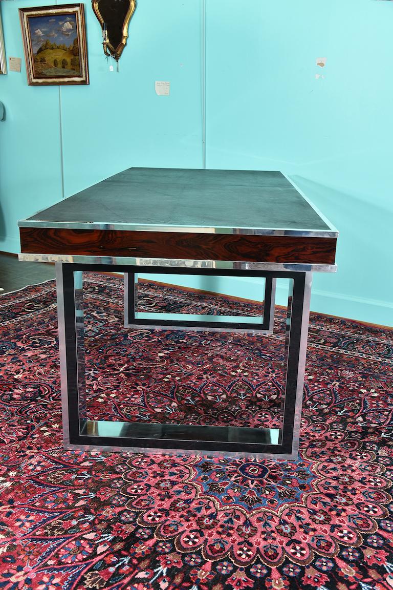 Midcentury French desk

Desk is rectangular table top, re-upholstered in a new graphite cowhide. It has a chrome trimming at the edges and beautiful wood grain is displaying on the sides of the table top. 2 legs are made as a rectangular with an