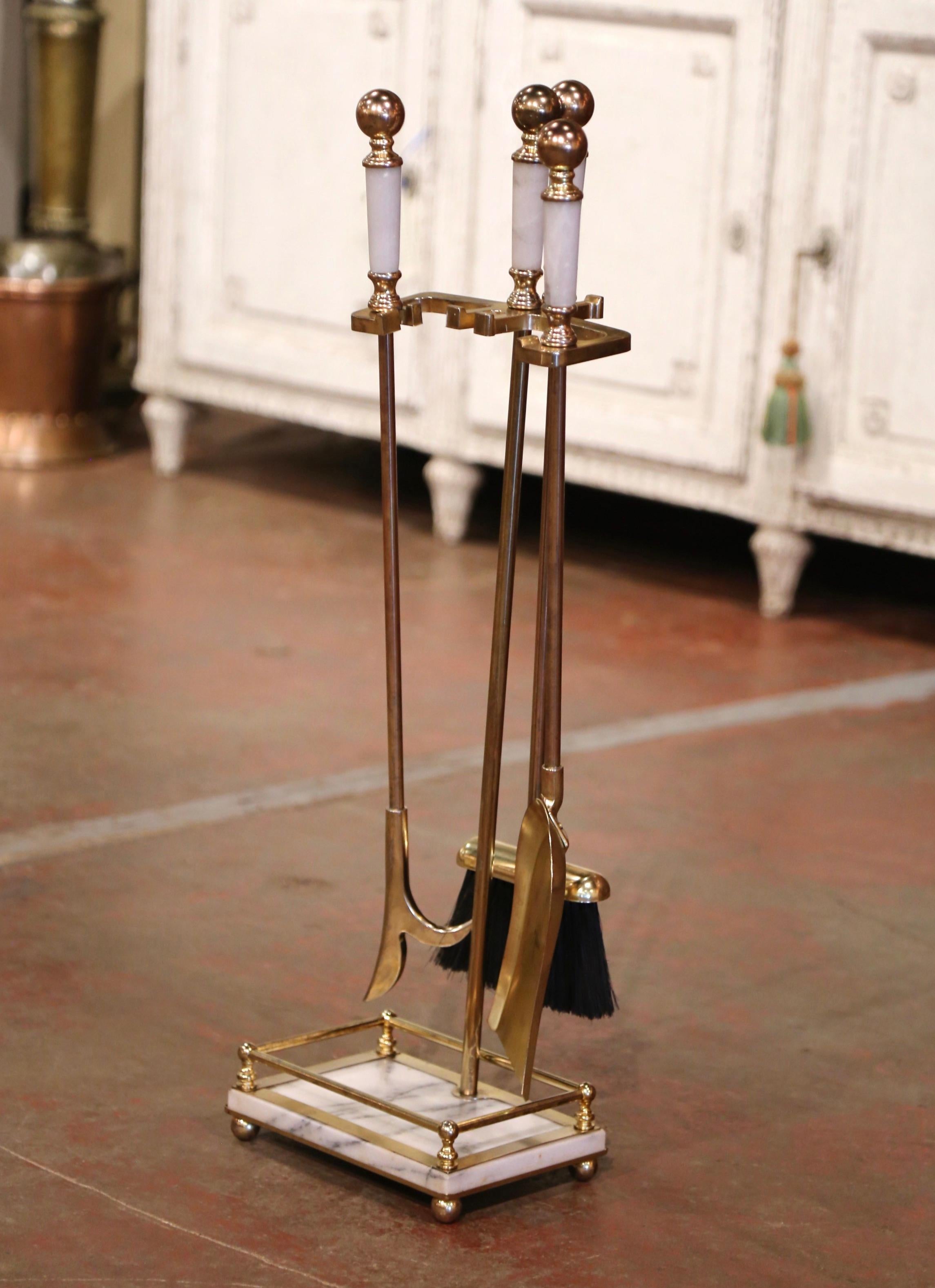 Place this elegant antique fireplace tool set next to your mantel. Crafted in France circa 1950, the brass Rococo 