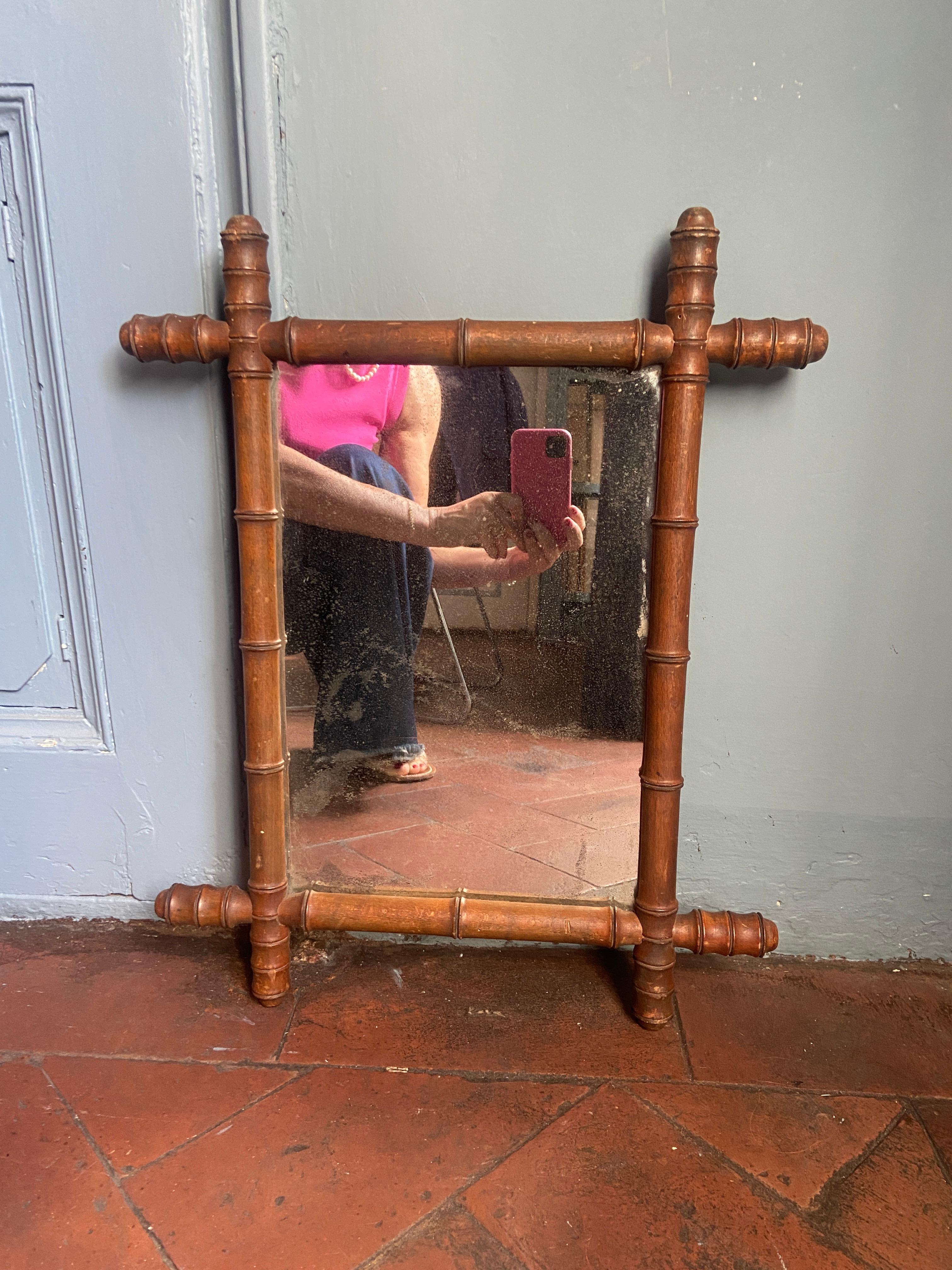 Mid-Century French Faux Bamboo Wall Mirror with oak wood frame and original mirror.
The mirror has a beautiful patina due to age and use