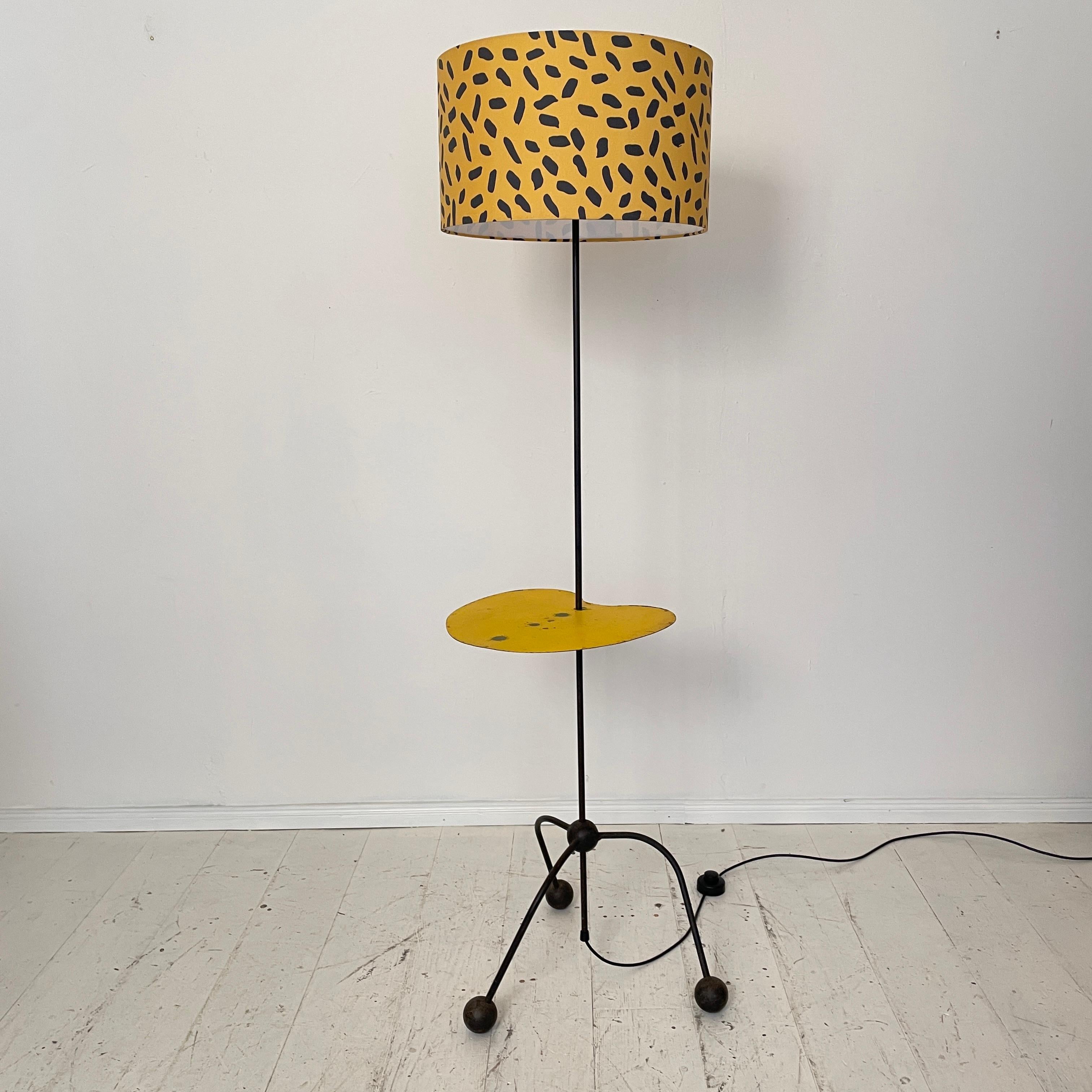 This beautiful mid-century French floor lamp was made in the 1950s.
It is a one of a kind piece.
The lampshade has been renewed and the table is adjustable in height.
It is made out of black lacquered metal and has got a yellow fabric shade.
A