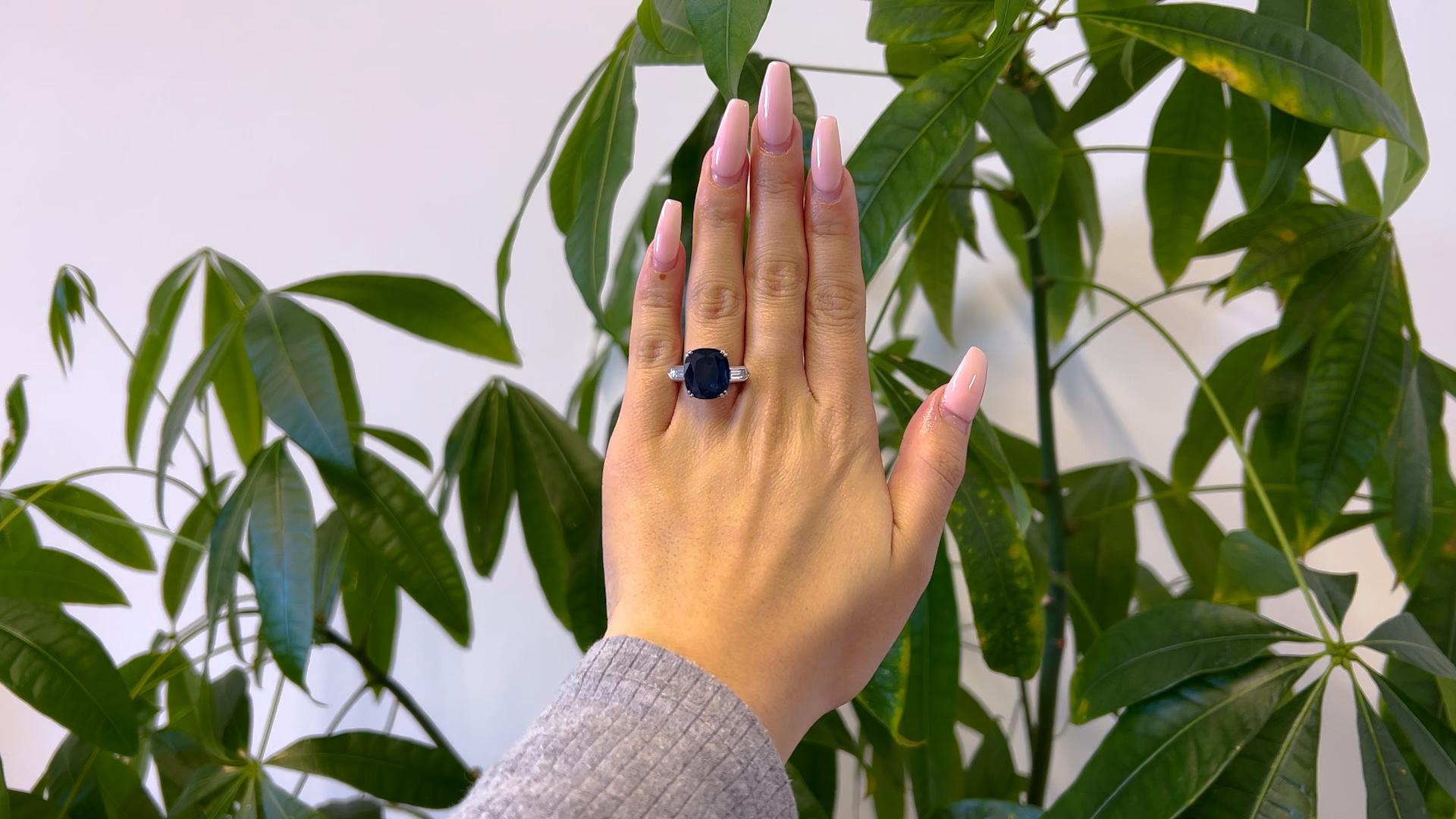 One Mid Century French GIA 8.33 Carat Sapphire and Diamond Platinum Ring. Featuring one GIA cushion mixed cut blue sapphire of 8.33 carats, accompanied with GIA #1236072969 stating the sapphire is of Thailand origin. Accented by two baguette cut
