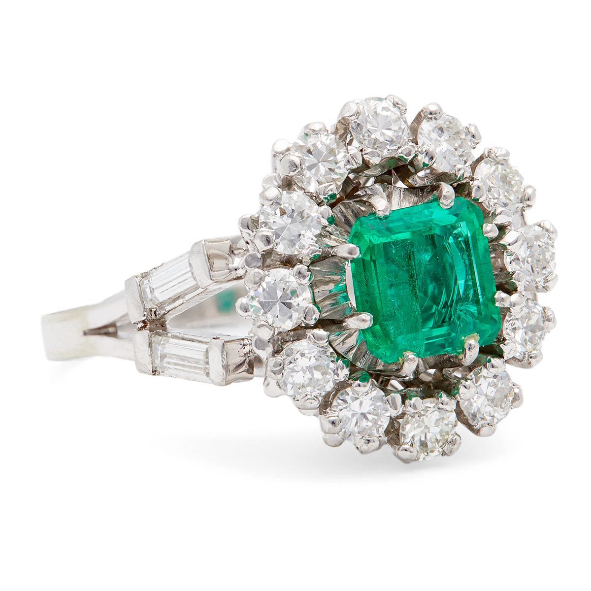One Mid Century French GIA Colombian Emerald and Diamond 18k White Gold Cluster Ring. Featuring one GIA octagonal step cut emerald weighing approximately 0.80 carat, accompanied with GIA #6227947025 stating the emerald is of Colombian origin.