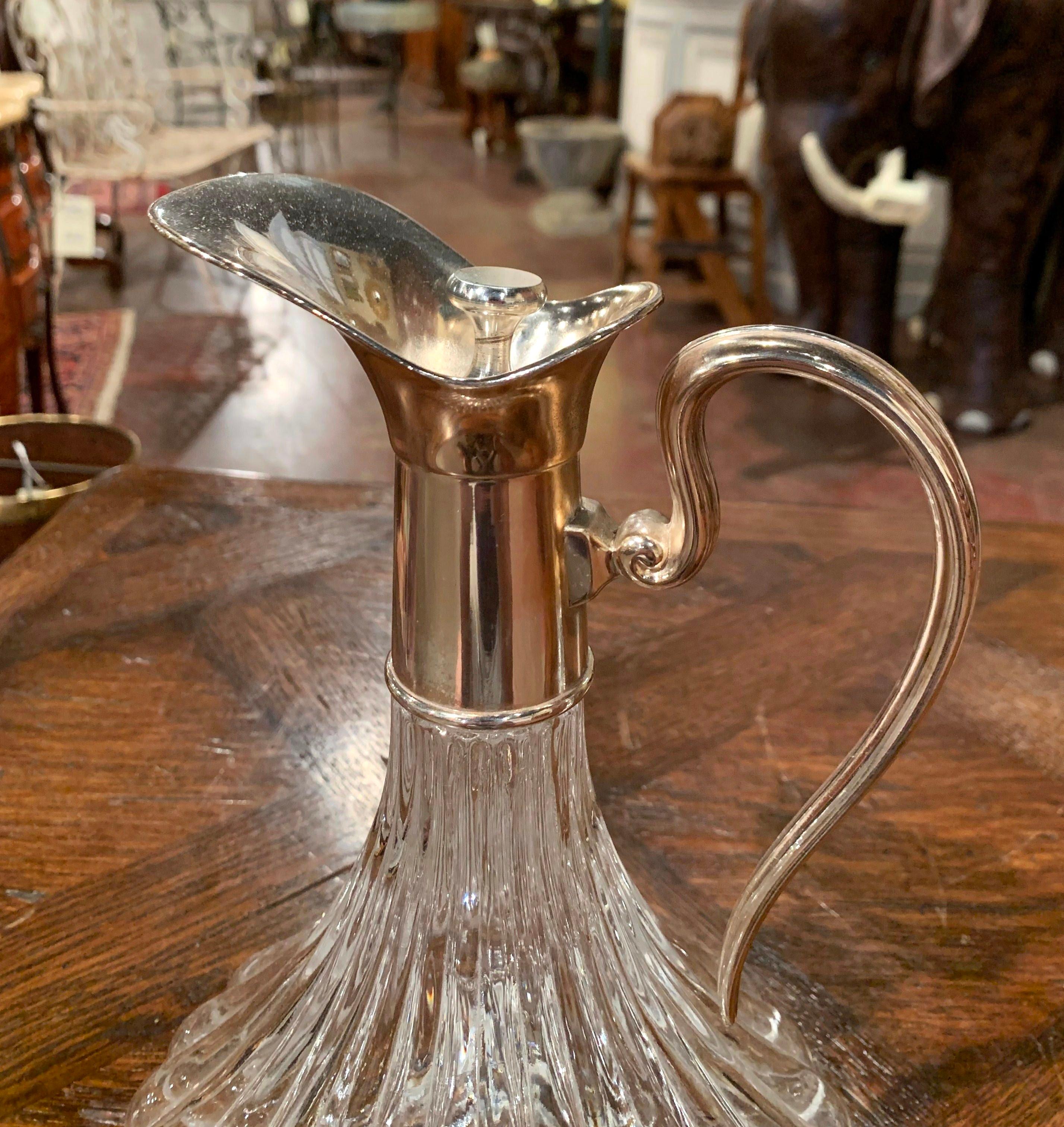 Let your red Bordeaux or Cabernet breeze in this elegant vintage wine carafe. Crafted in France, circa 1960, the decanter has the original cork stopper with silver knob, a wide mouth in brass with silver plate, and a curved pouring handle. The cut
