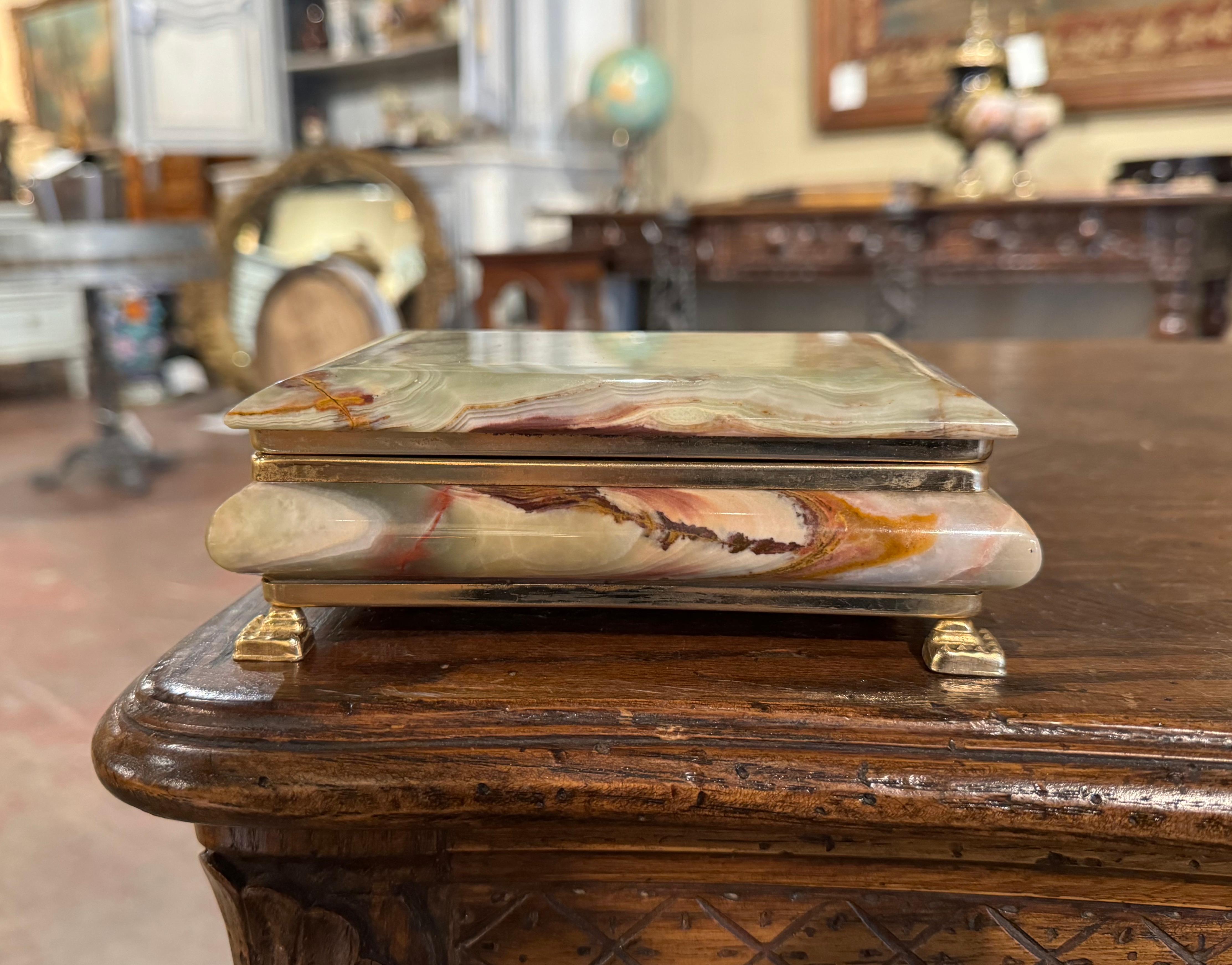 Keep your jewelry safe in this elegant antique marble box. Created in France circa 1950, the casket sits on small square feet. The top open and reveals an inside red felt and a mirrored back. The decorative jade box is in excellent condition and