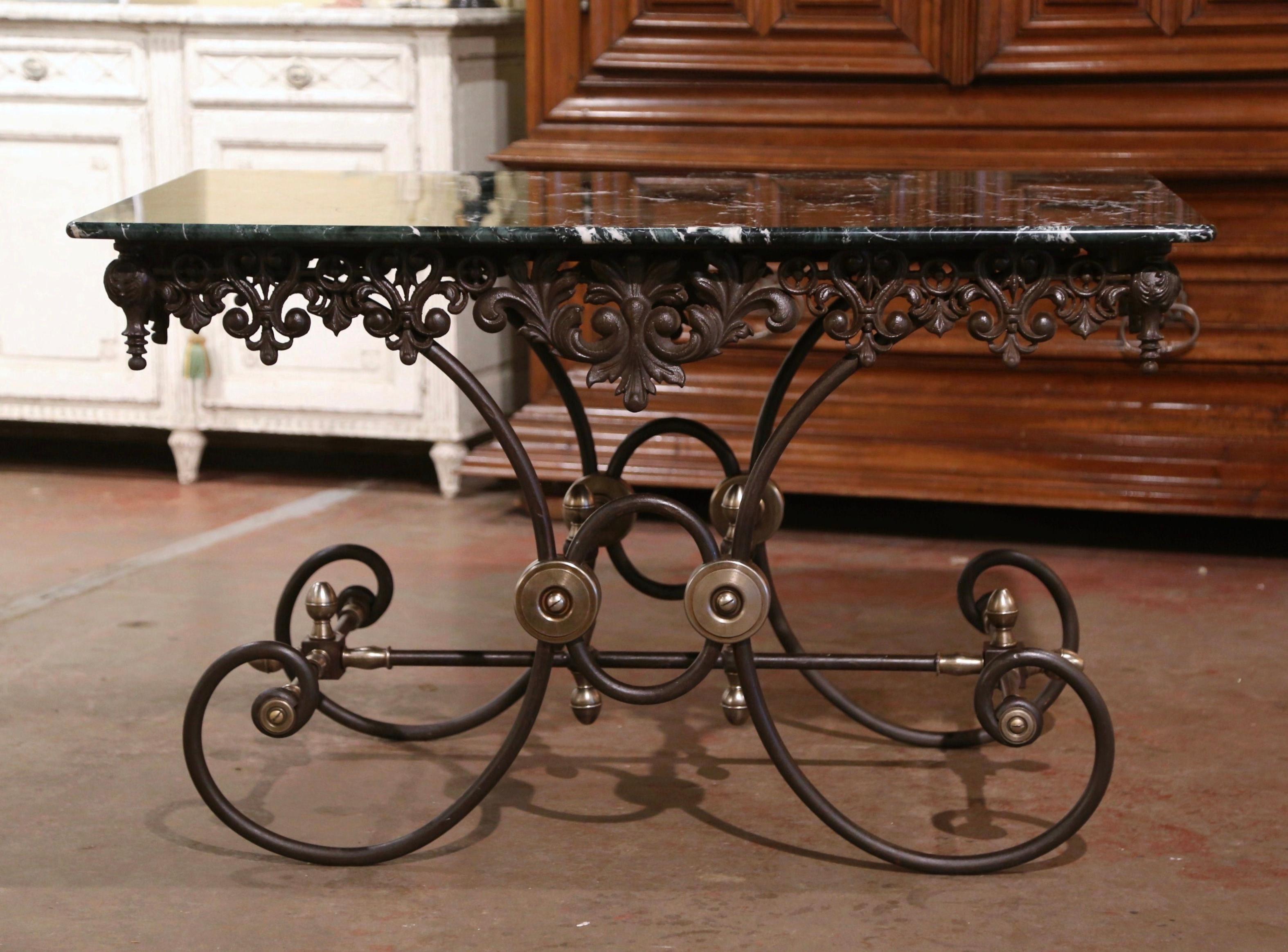 Crafted in France circa 1960, this antique pastry table stands on scrolled legs over an intricate stretcher embellished with decorative bronze mounts, rosettes and finials. The table features a decorative scalloped and pierced apron on all four