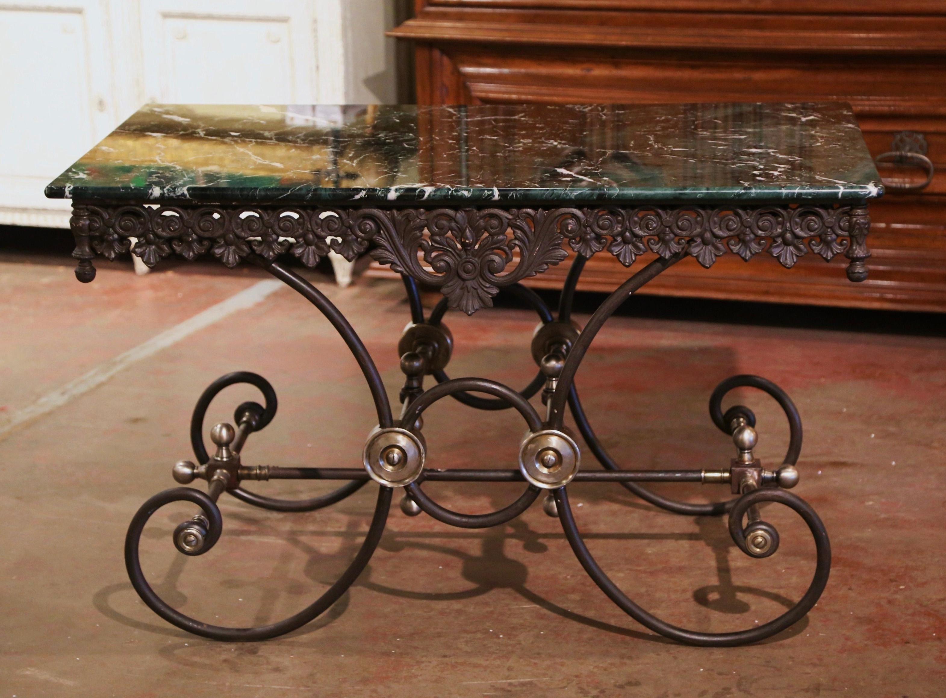 Crafted in France circa 1960, this antique pastry table stands on scrolled legs over an intricate stretcher embellished with decorative bronze mounts, rosettes and finials. The table features a decorative scalloped and pierced apron on all four