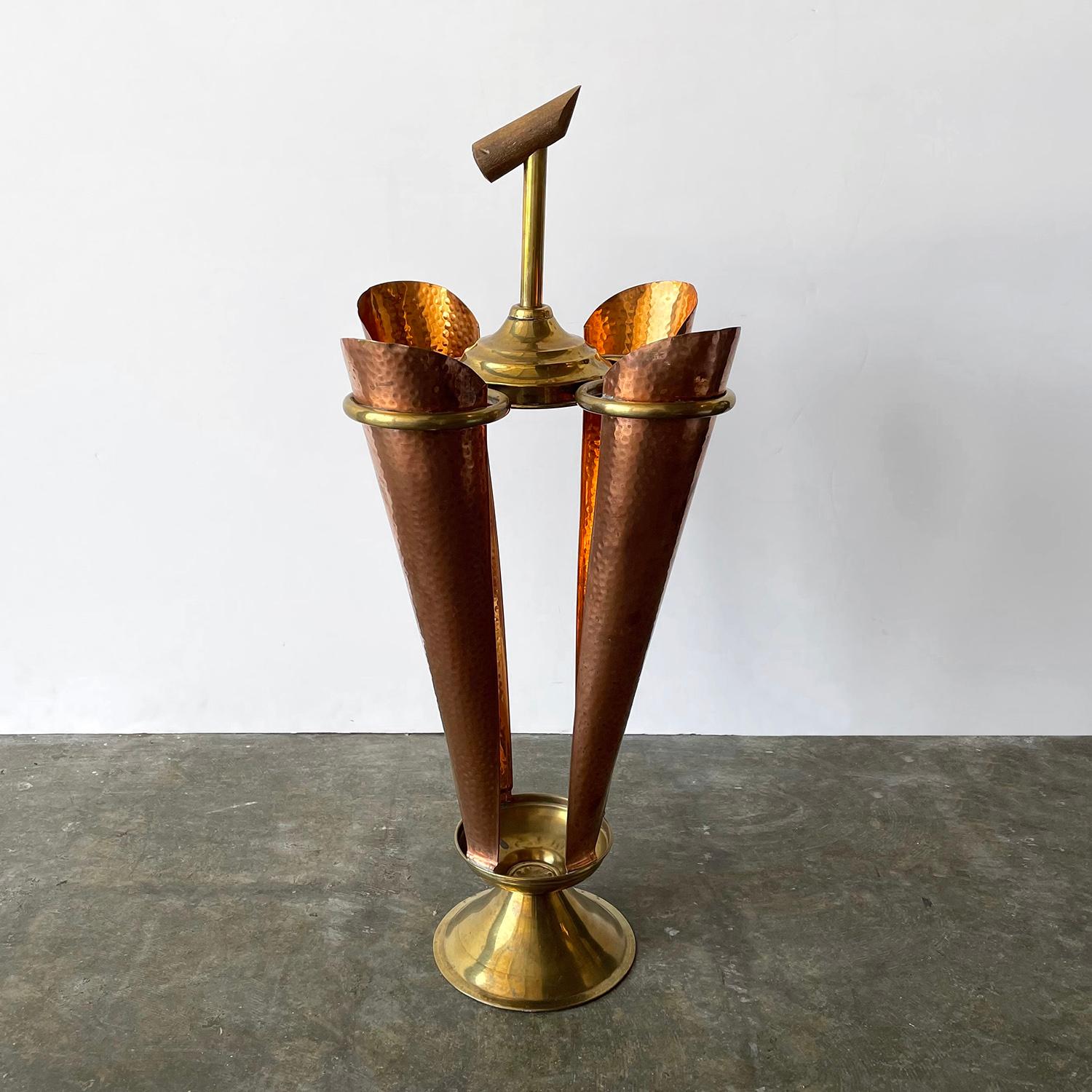French hammered copper and brass umbrella holder
Rustic piece that has lived well with more life to give!
Perfectly imperfect hammered brass sleeves
Brass details and wooden handle
Patina from age and use
Timeless classic 
