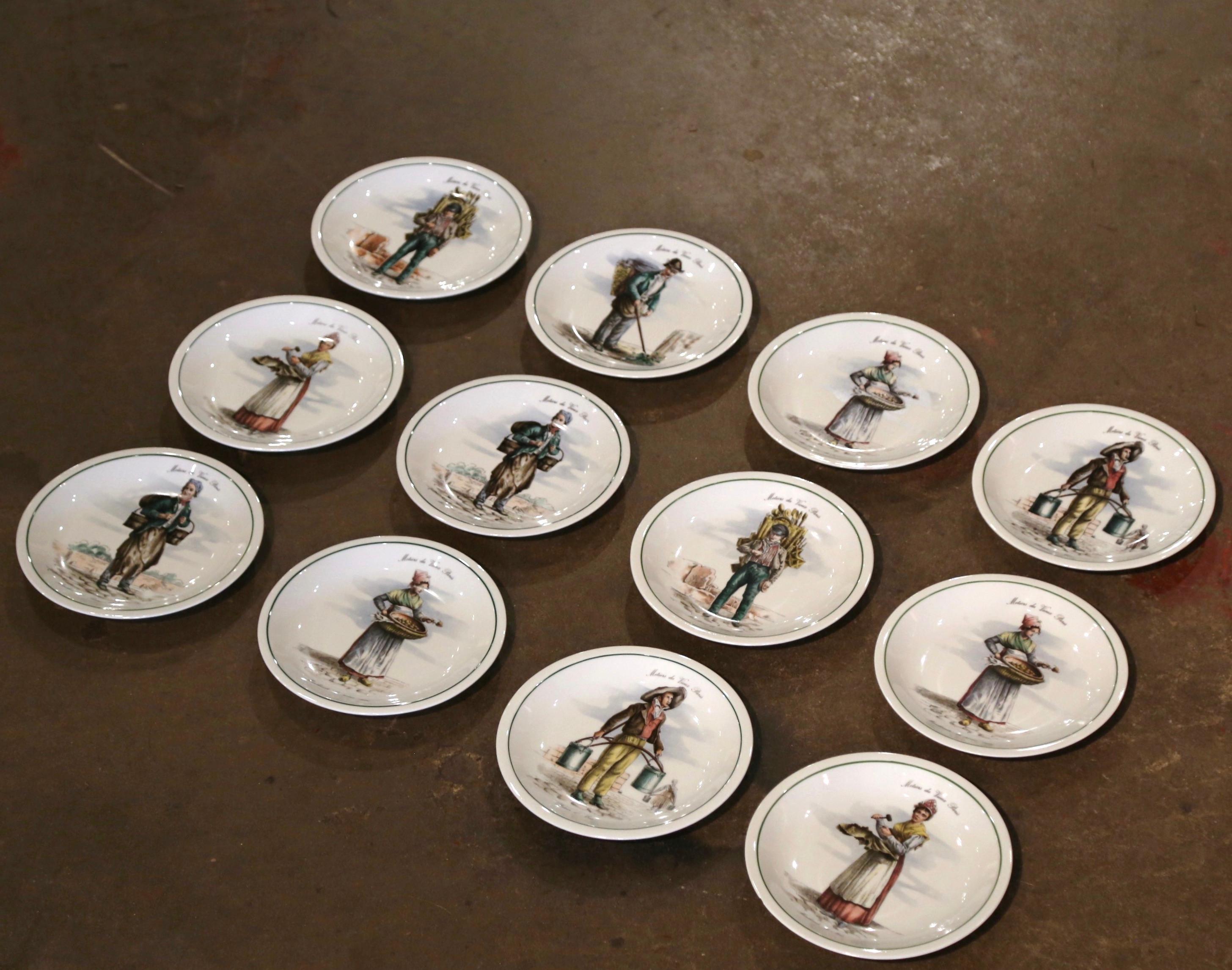 Decorate a vaisselier or a shelf with this colorful set of antique plates. Crafted in Paris circa 1970 by F. D. Chauvigny, each porcelain plate is hand painted and depicts a 