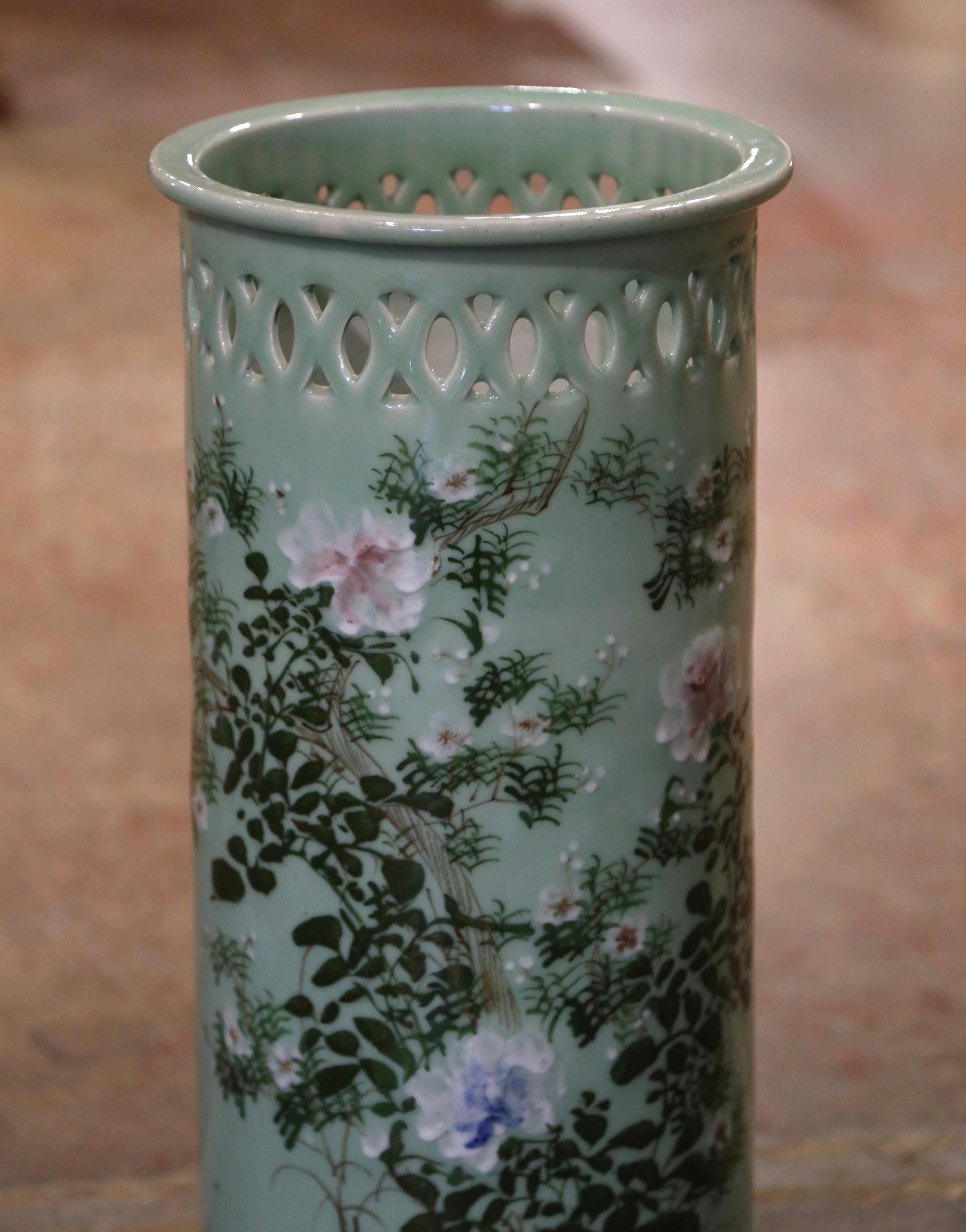 Place this tall, elegant stand at your front door or in your mudroom to catch loose canes and umbrellas. Crafted in France, circa 1960, the circular porcelain umbrella basket sits on a round base and features hand painted floral decor with high