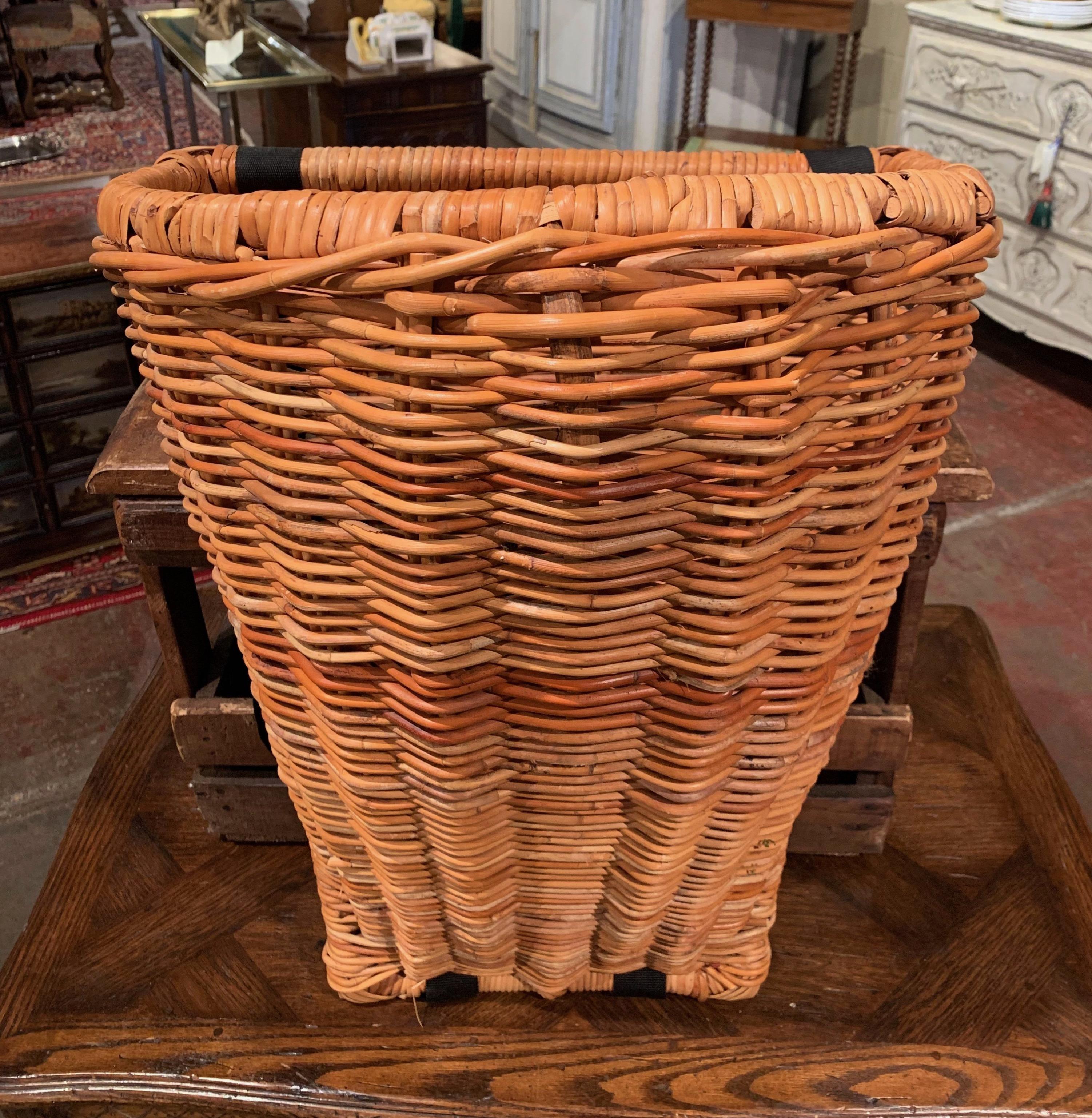 Decorate a wine cellar with this antique, grape harvest basket. Created in Eastern France circa 1950, the unique basket is tapered shaped and made of handwoven wicker. The basket is in excellent condition and features the original back straps. This