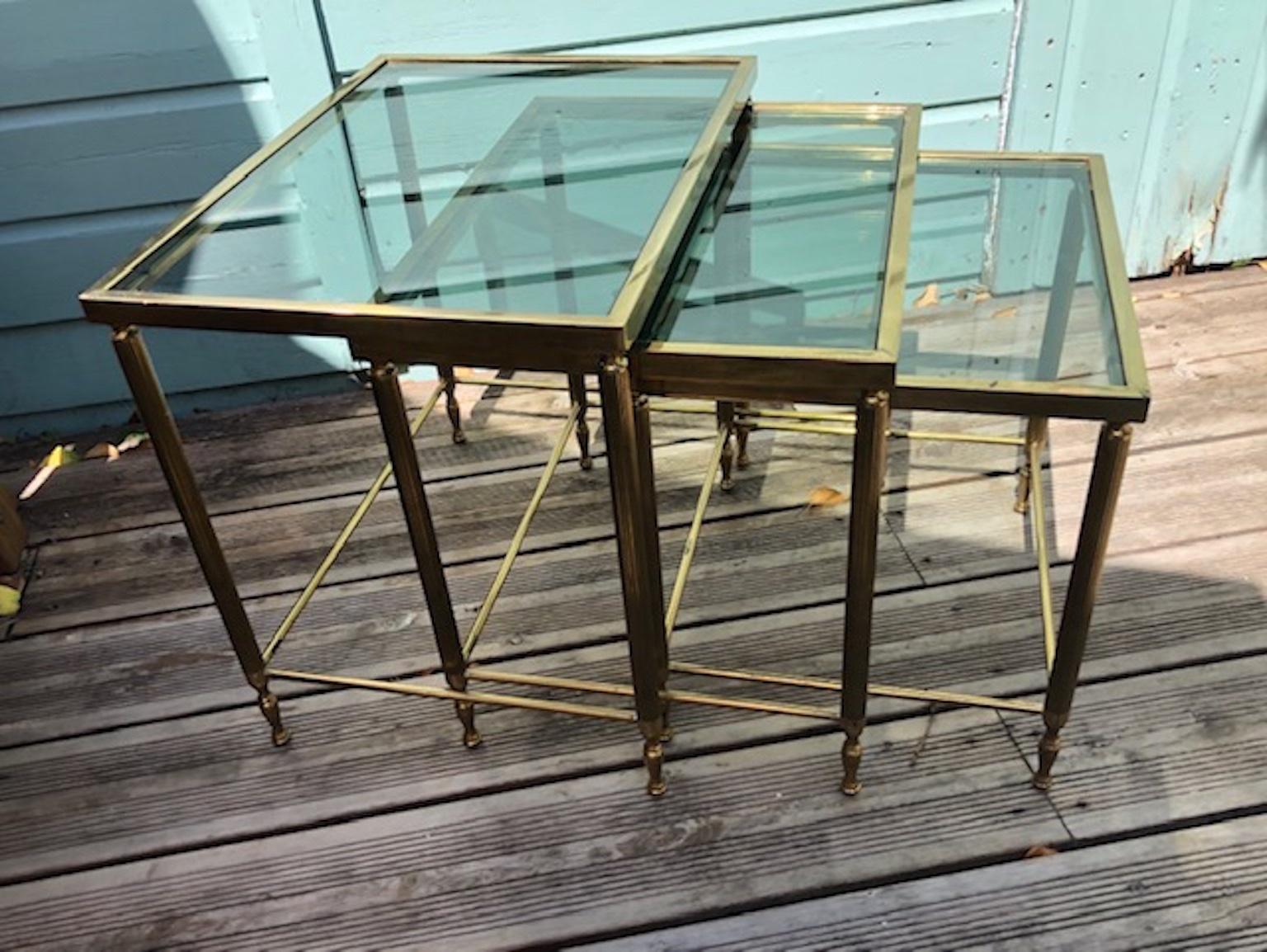 Mid Century French Hollywood Regency brass nest of tables, French, circa 1950s

A set of superb quality midcentury French brass nesting tables, produced in France during the 1950s, Attributed to Maison Jansen. 

The neoclassical and modernist