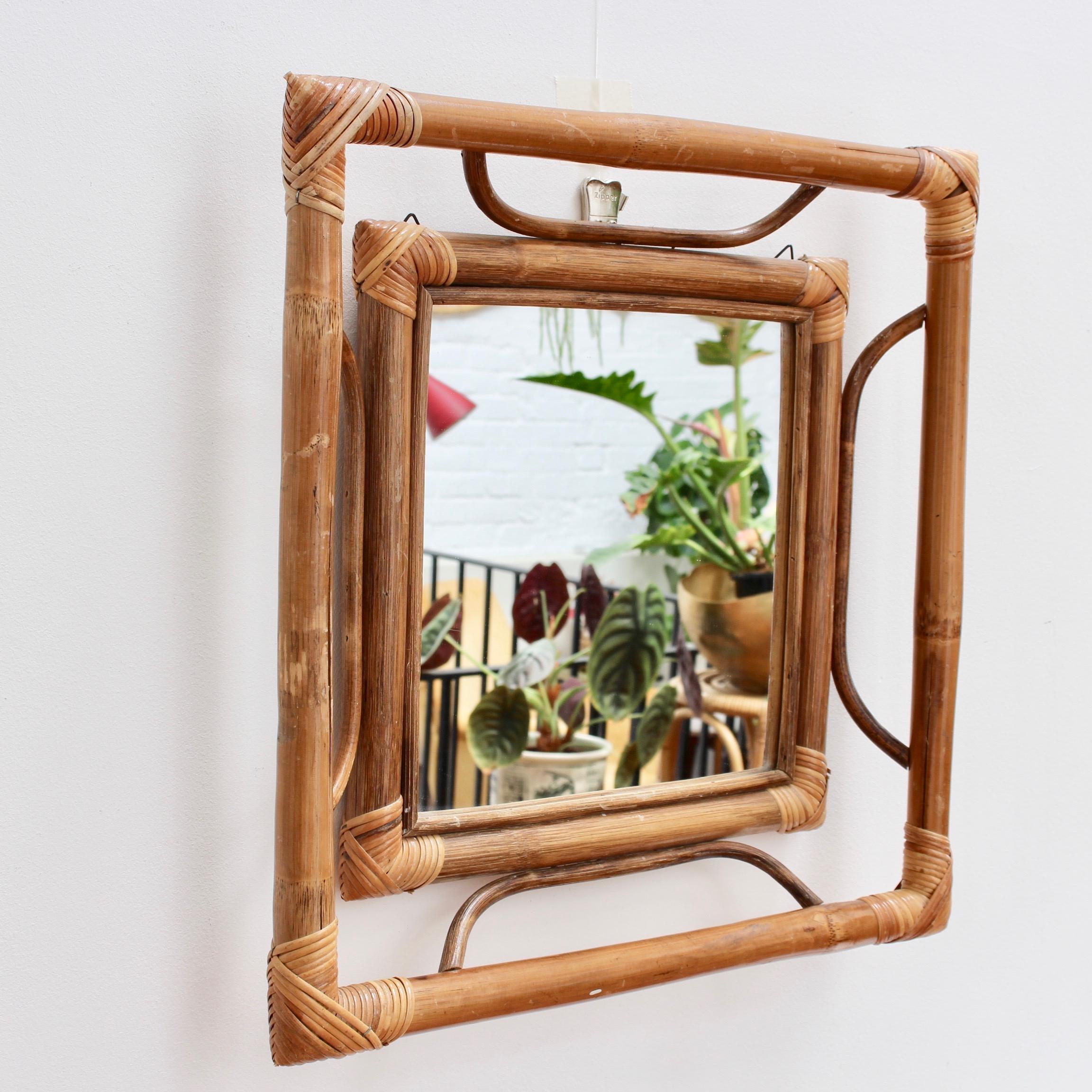 Midcentury French Indochine-style bamboo and rattan wall mirror (circa 1960s). A very unusual and rare find with a framed square mirror within a larger square bamboo frame - a frame within a frame. The minimalist styling features bamboo and rattan