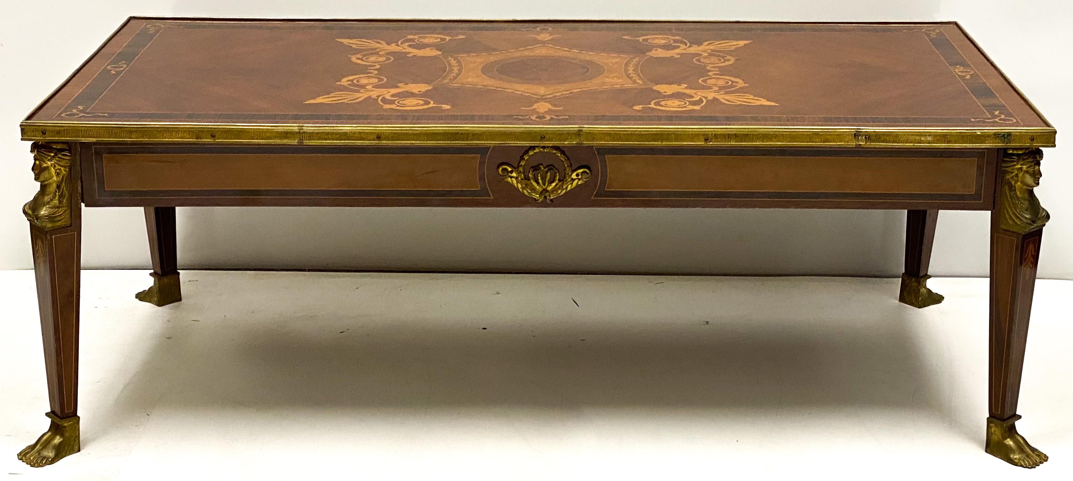 This is a neoclassical style French inlaid coffee table with bronze mounts. It is not marked and in very good condition. The woods are mahogany and satinwoods.