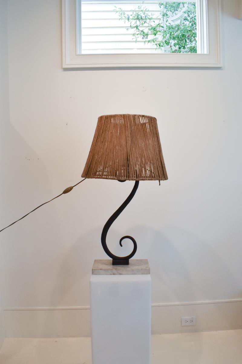 One of a kind mid-century table lamp crafted of wrought iron in a dramatic S-curve mounted on a white marble base. The shade is created from string carefully wound around a frame. This unique lamp has an engaging presence.