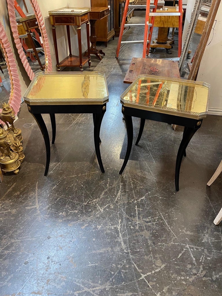 Lovely pair of mid-century French Jansen style black side tables with gold foil tops. A fabulous decorative element! Note: Price listed is per piece.