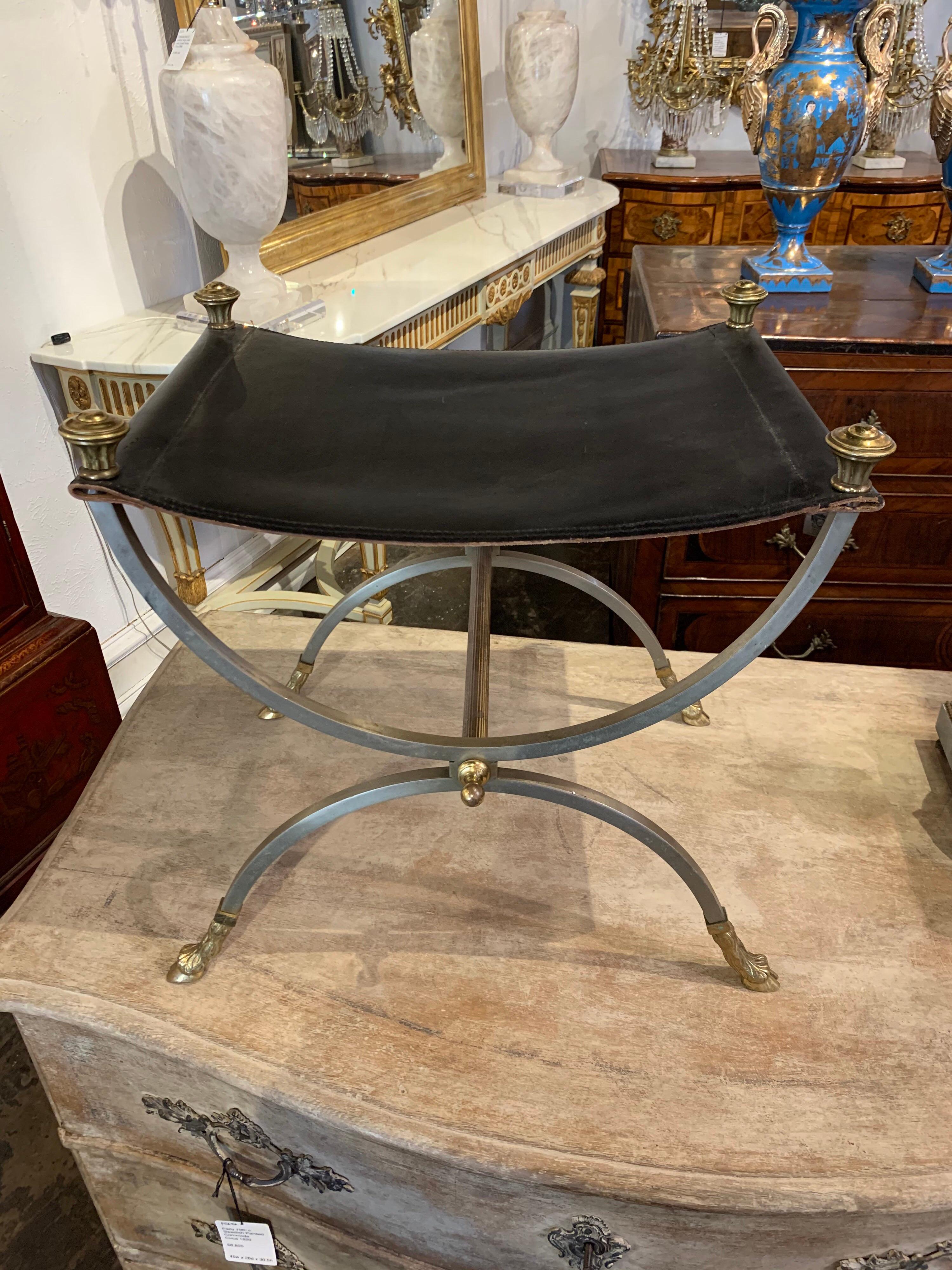 Handsome midcentury French Jansen style brass and leather stool. Nice details on the feet and on the top of the piece. A lovely decorative accent!