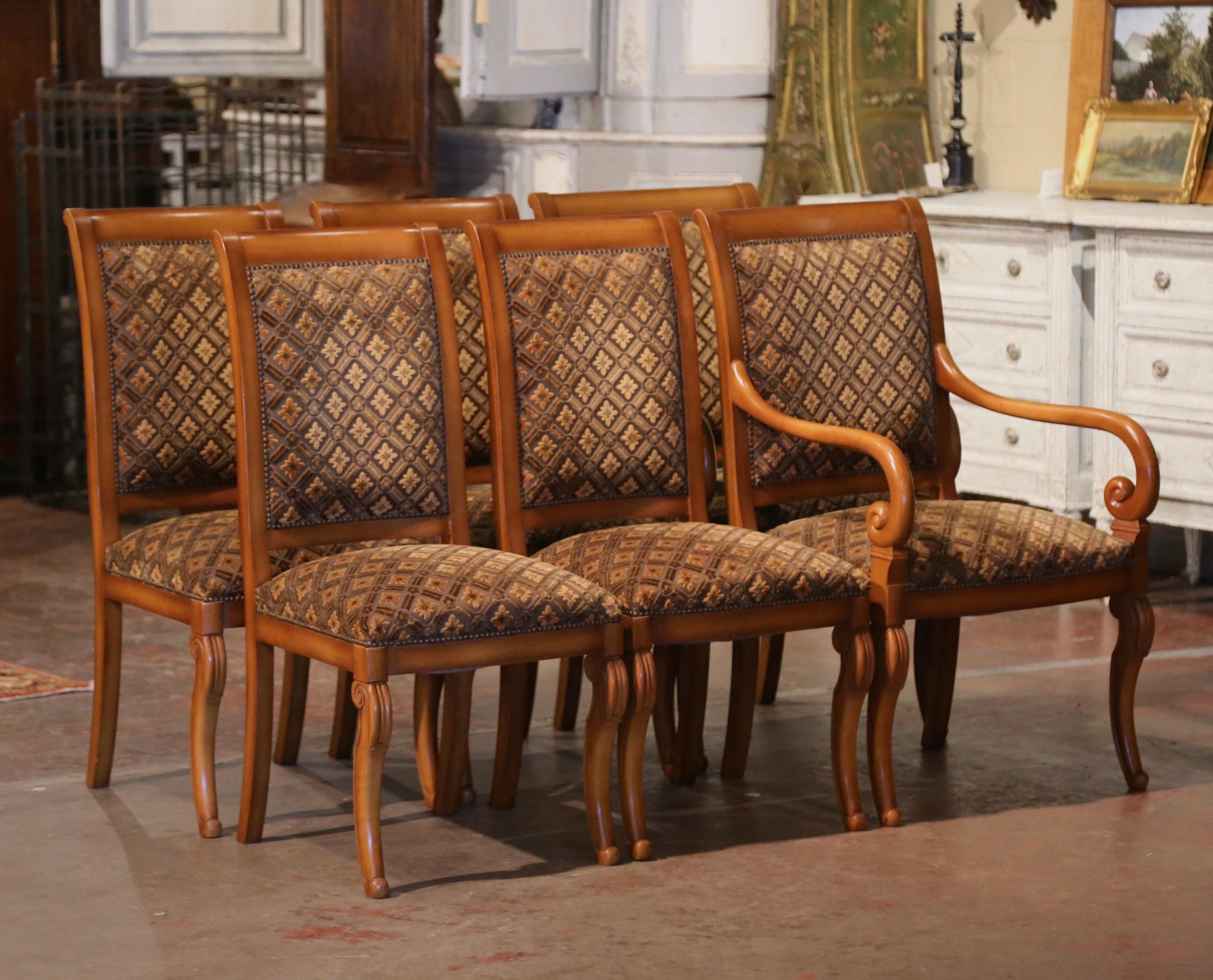 Dress a breakfast table with this elegant set of four sidechairs and matching armchairs. Crafted in France circa 1970 from walnut wood, each chair stands on cabriole legs ending in scroll feet over a straight bombe apron. Each chair has a wide and