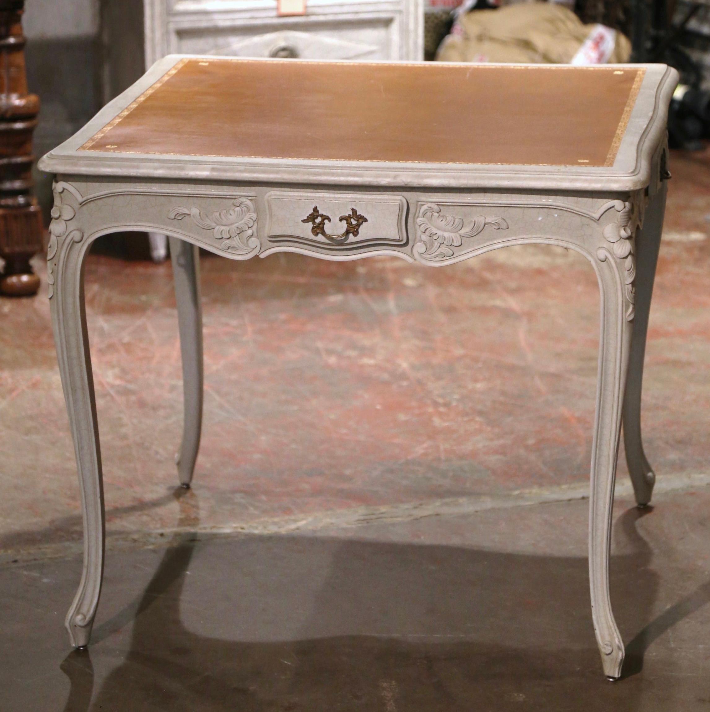 Crafted in France circa 1960 and square in shape, the table stands on cabriole legs decorated with floral and acanthus leaf motifs at the shoulders over scroll feet at the base. The table with a scalloped apron is decorated with carved floral and