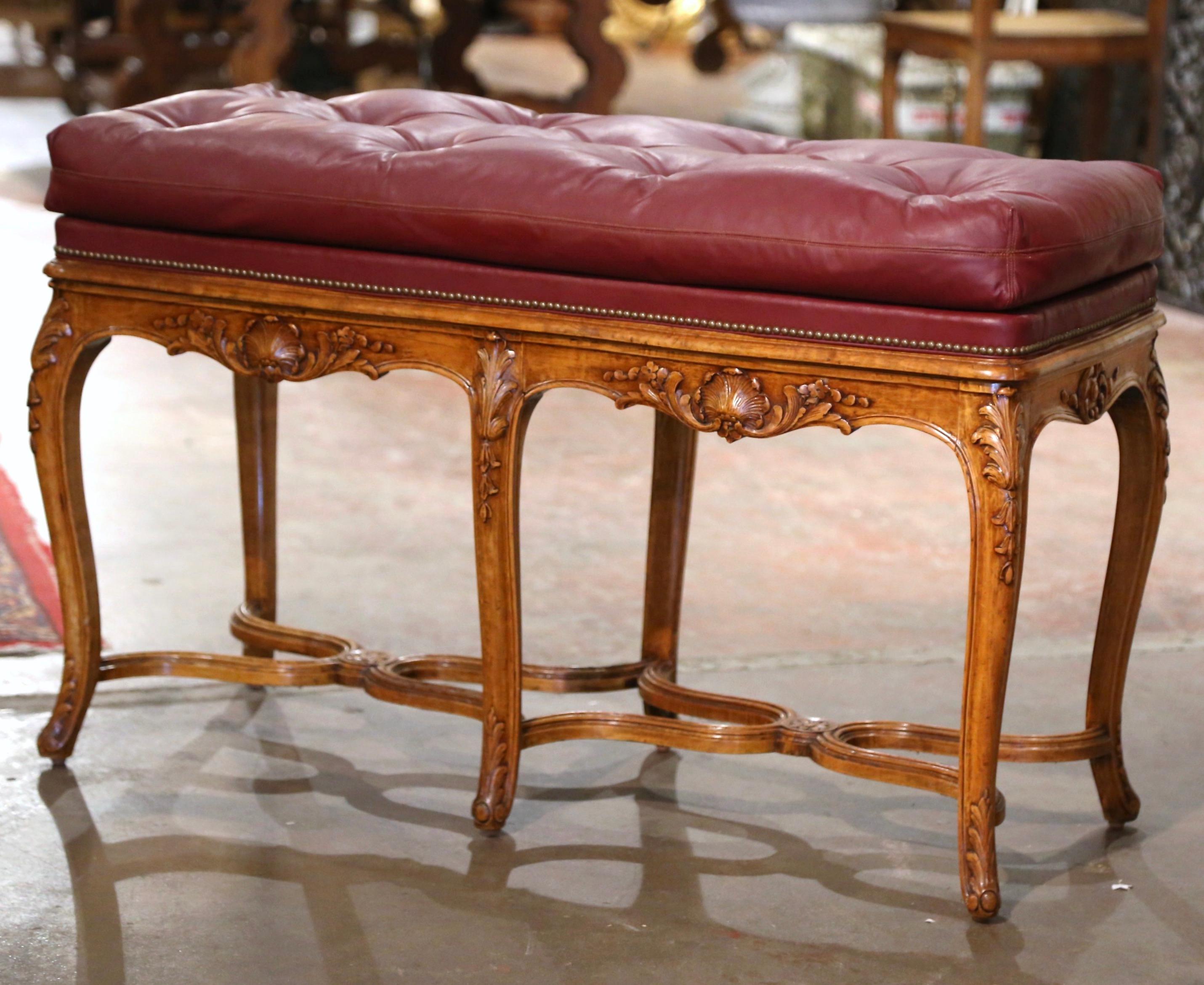 Crafted in Provence, France, circa 1970, the tall vintage fruitwood bench stands on six cabriole legs ending with scrolled feet over a double curved X stretcher at the base. Each leg is further embellished with hand carved acanthus leaf at the