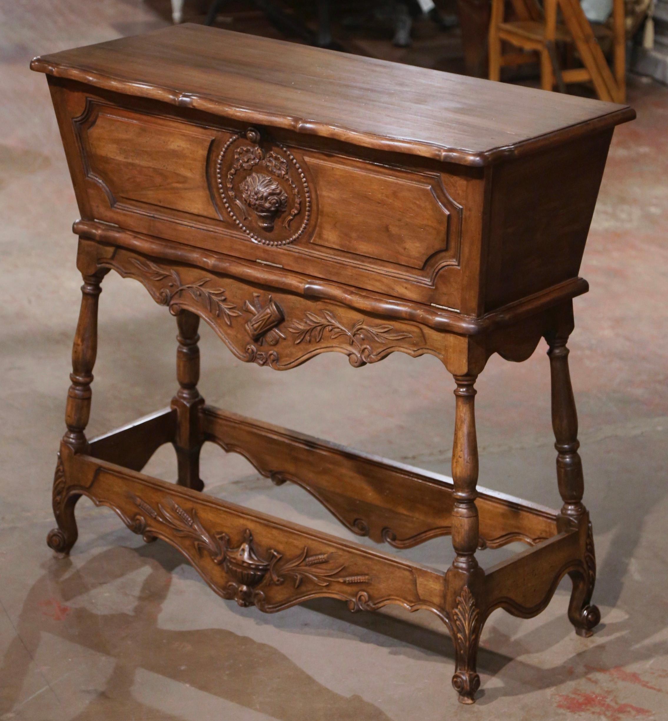 This antique fruit wood dough box was created in Provence, France circa 1950. Heavily carved from top to bottom, the 