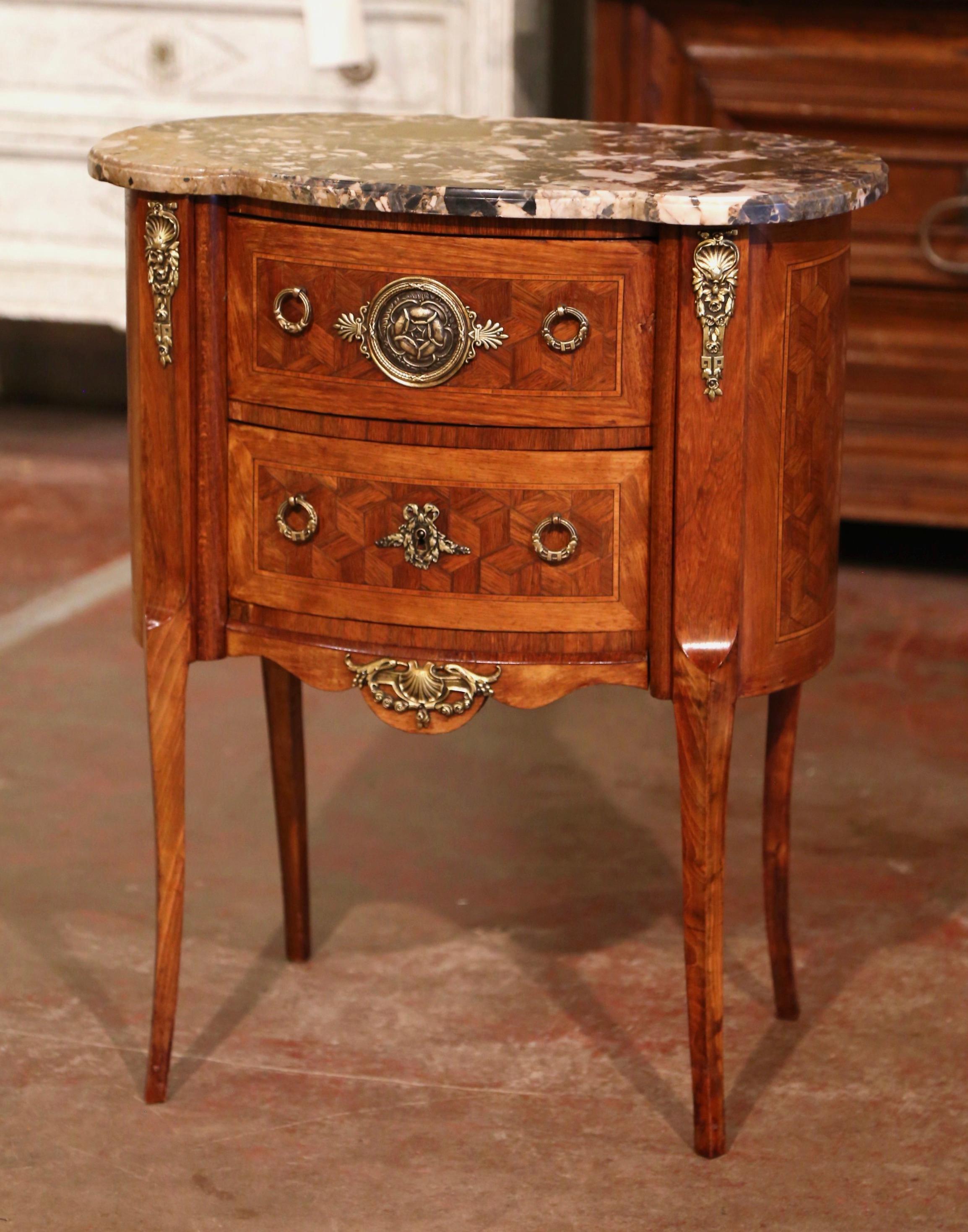This elegant, kidney-shaped fruitwood antique commode was crafted in France, circa 1950. The commode sits on cabriole legs ending with bronze sabot mounts over the feet. The bow front, over a scalloped apron embellished with a center decorative