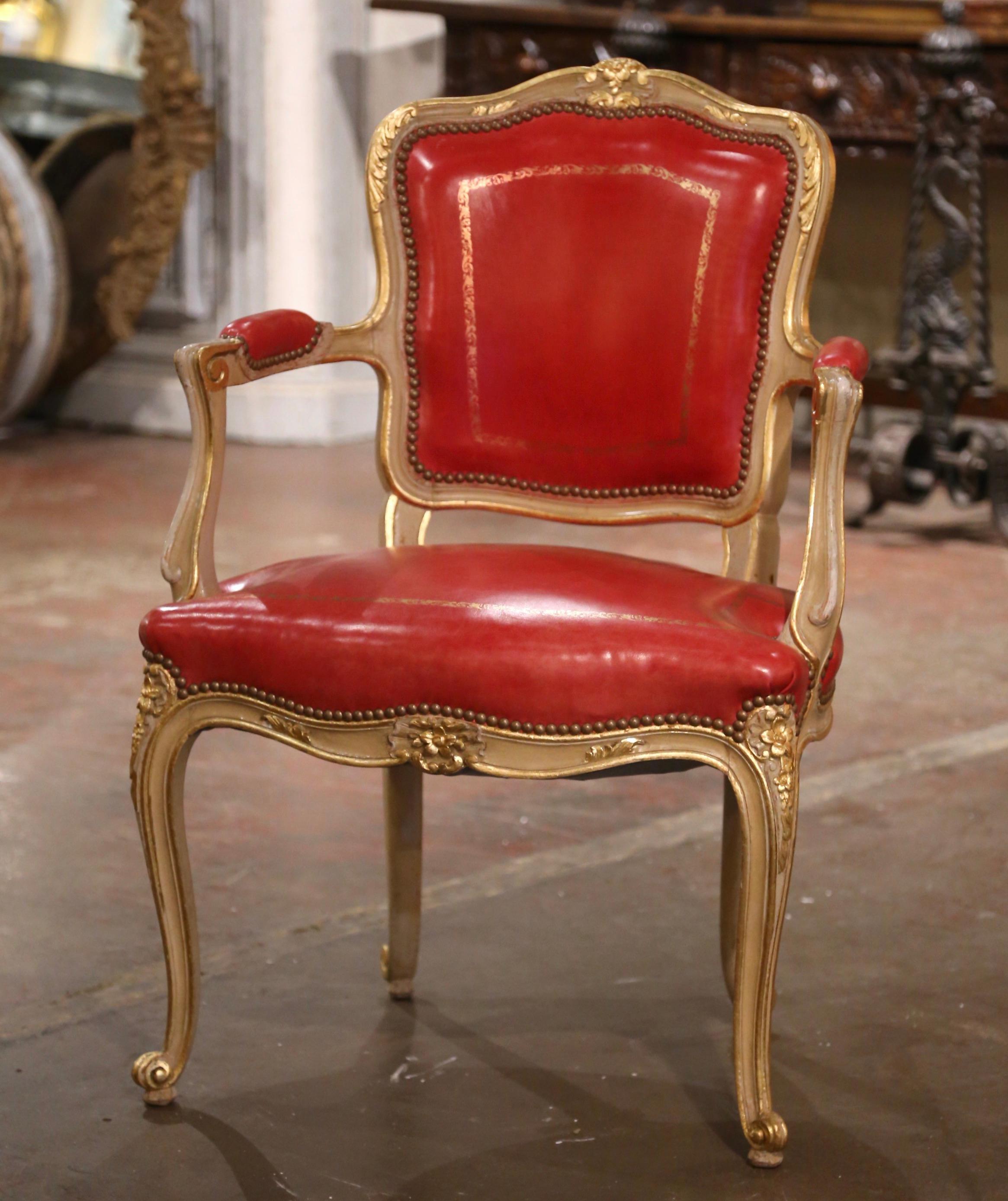 Add a pop of color to your office or study with this elegant antique painted and gilt desk armchair. Crafted in Provence France circa 1960, the chair stands on cabriole legs decorated with carved floral motifs at the shoulder, and ending with