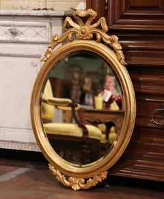 Mid-Century French Louis XVI Carved Giltwood Oval Wall Mirror with Beveled Glass