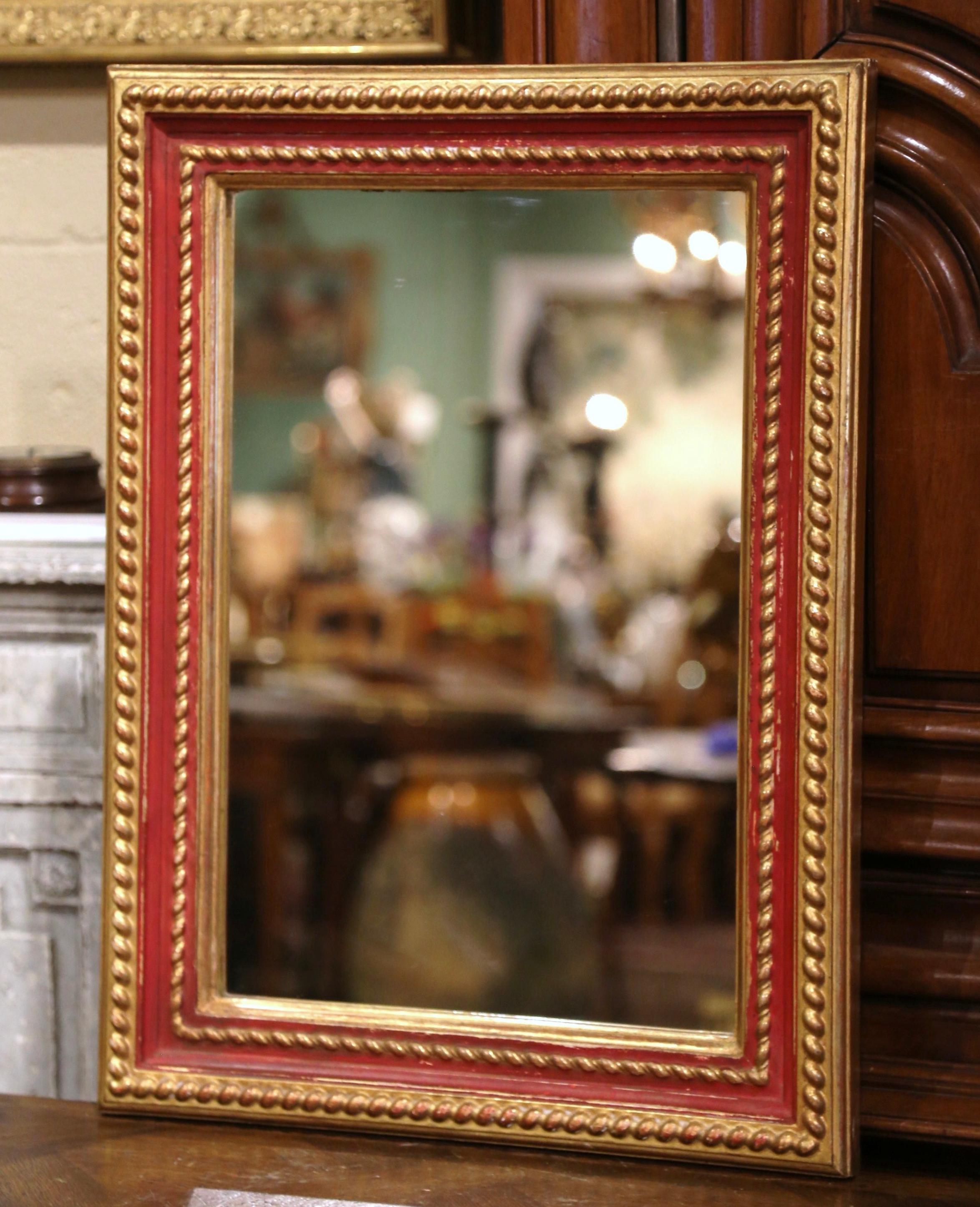 Place this versatile antique wall gilt mirror horizontally over a small buffet, or vertically in a powder room. Crafted in France, circa 1960, the rectangular giltwood frame is embellished with two bands of carved rope decor in high relief. The