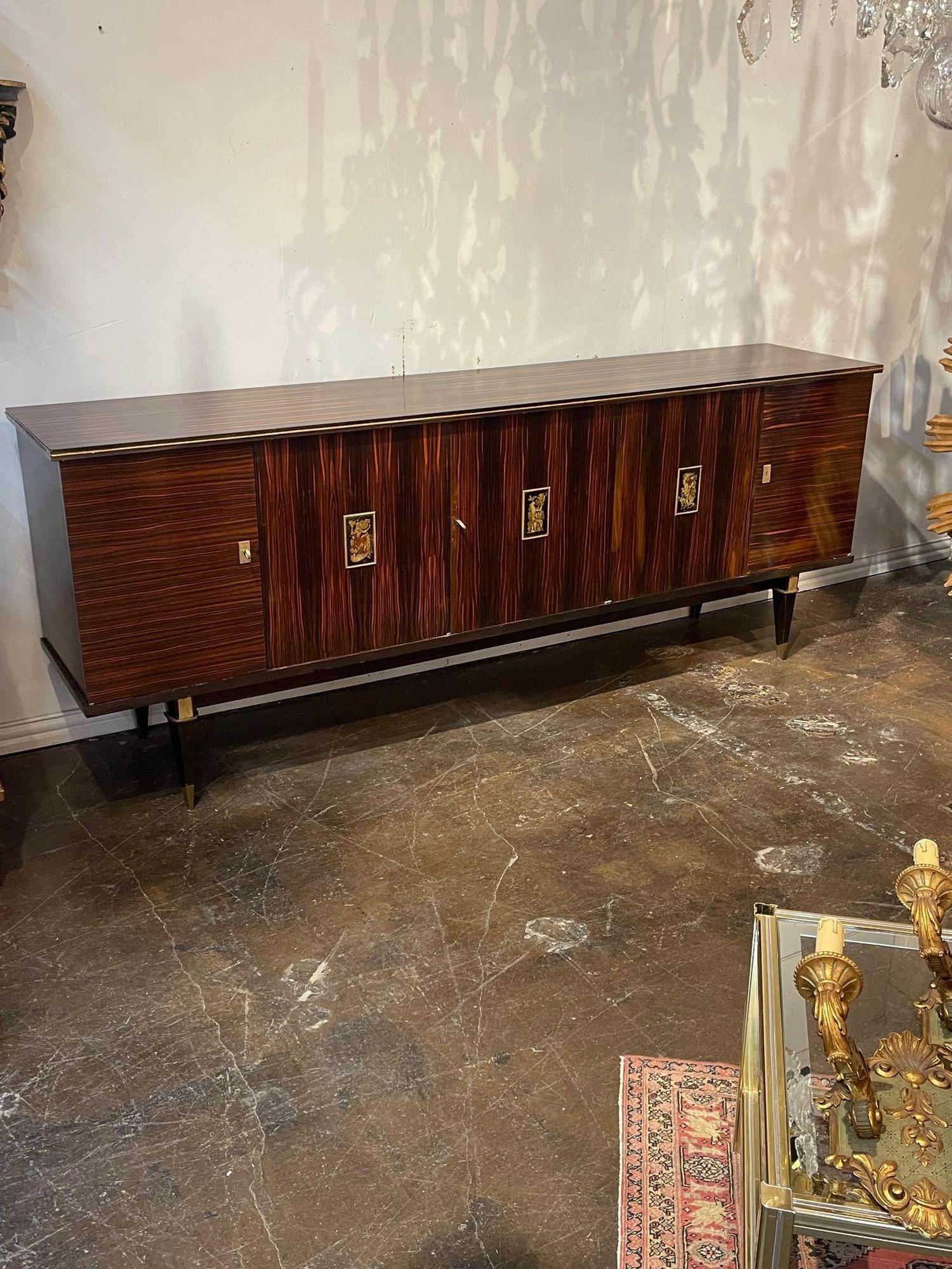 Handsome mid-century French Macassar and ebonized wood sideboard. This cabinet has an exceptional finish and tons of storage. This is a quality piece has that creates a very high-end look!