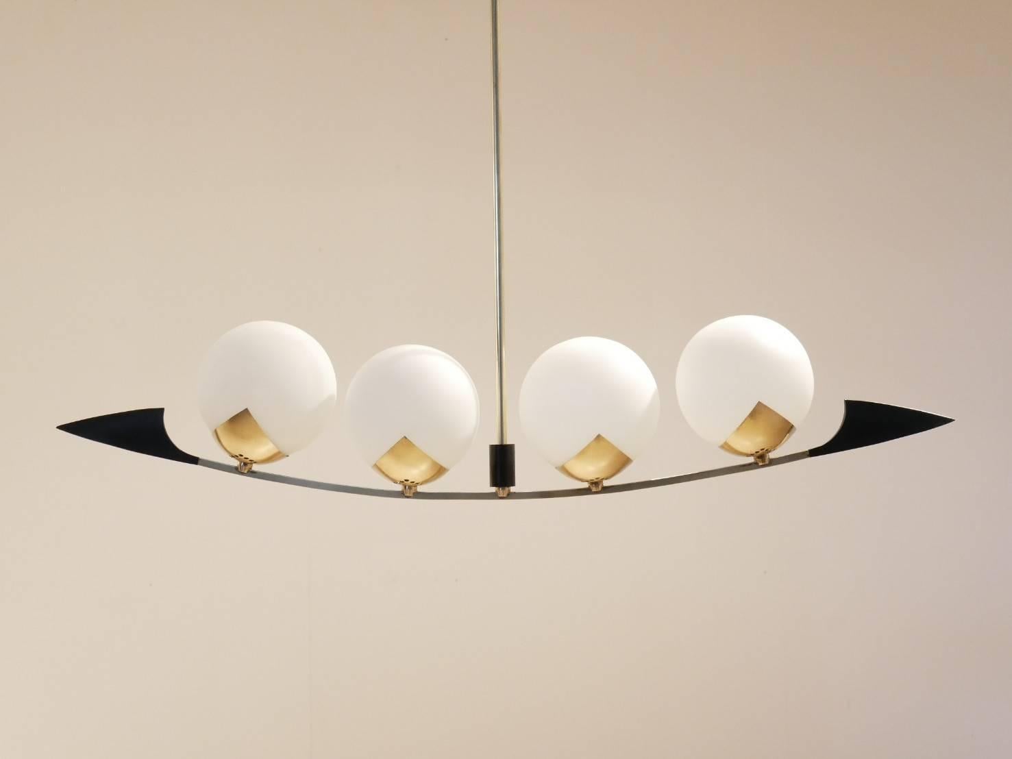 Delicate midcentury Maison Arlus chandelier, brass structure matched with round shaped opalescent glass diffusers.