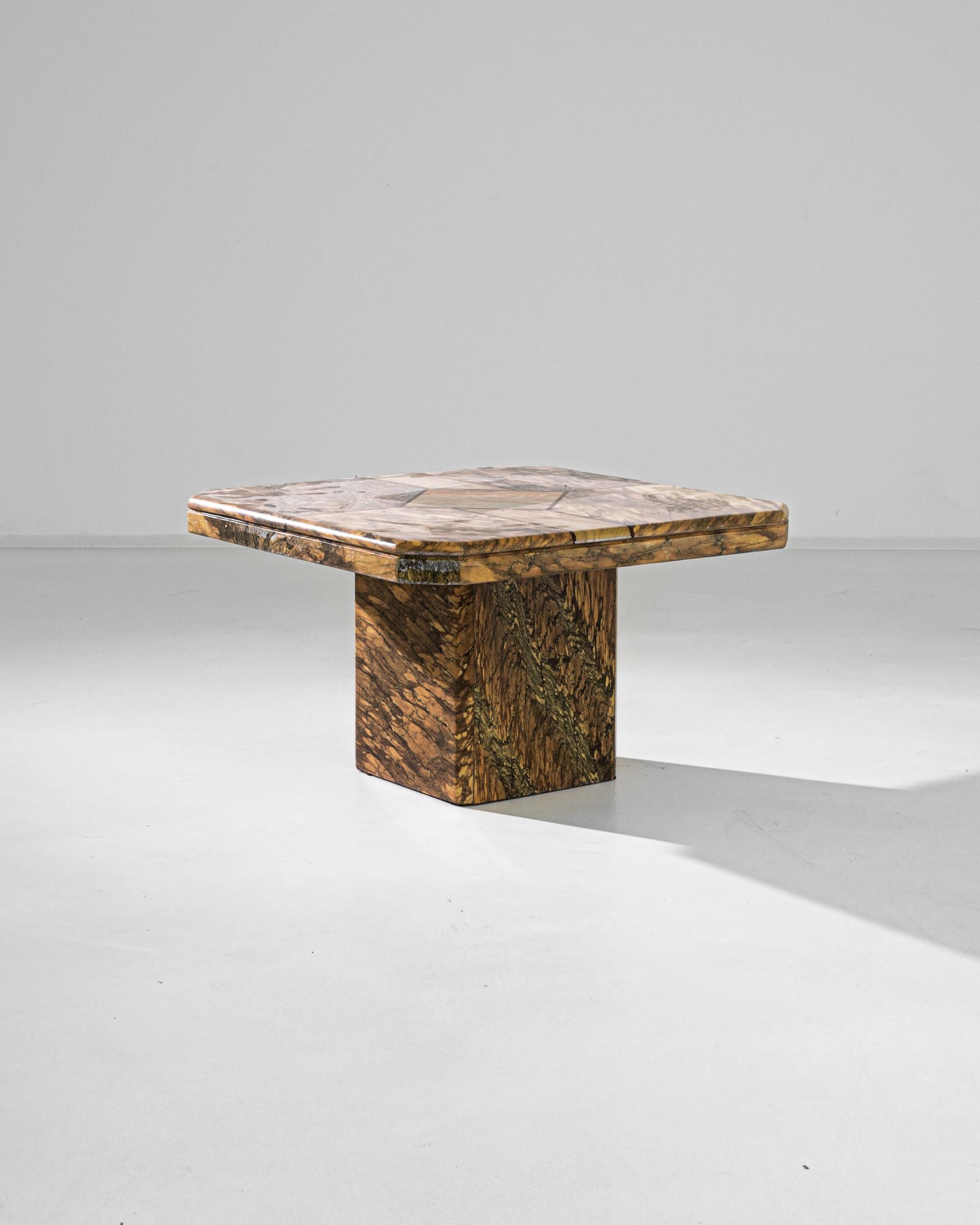 A marble coffee table from France, circa 1970. Conjoining geometric slabs of marble shape this piece into an ornate and sharp work of craftsmanship. Its lively web of marble veins running through the stone create a kinetic flow of detail around the