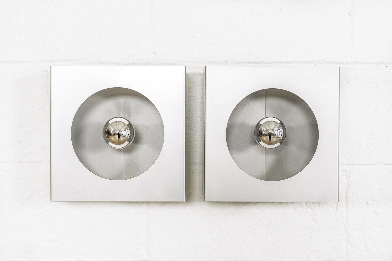 This rare pair of vintage midcentury French modern Model 2091 Disderot wall sconces were made in France in 1968. Well-crafted of heavy folded anodized aluminum in a matte silver finish, the unique space age, modernist design is meant to appear to