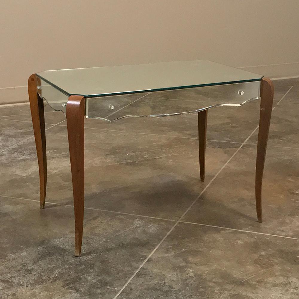 Midcentury French mirrored coffee table is a superb blend of natural wood with contoured mirrors that creates a graceful form that is also quite carefree! The subtly scrolled legs exude a hint of French flair, and appear on each corner at a 45