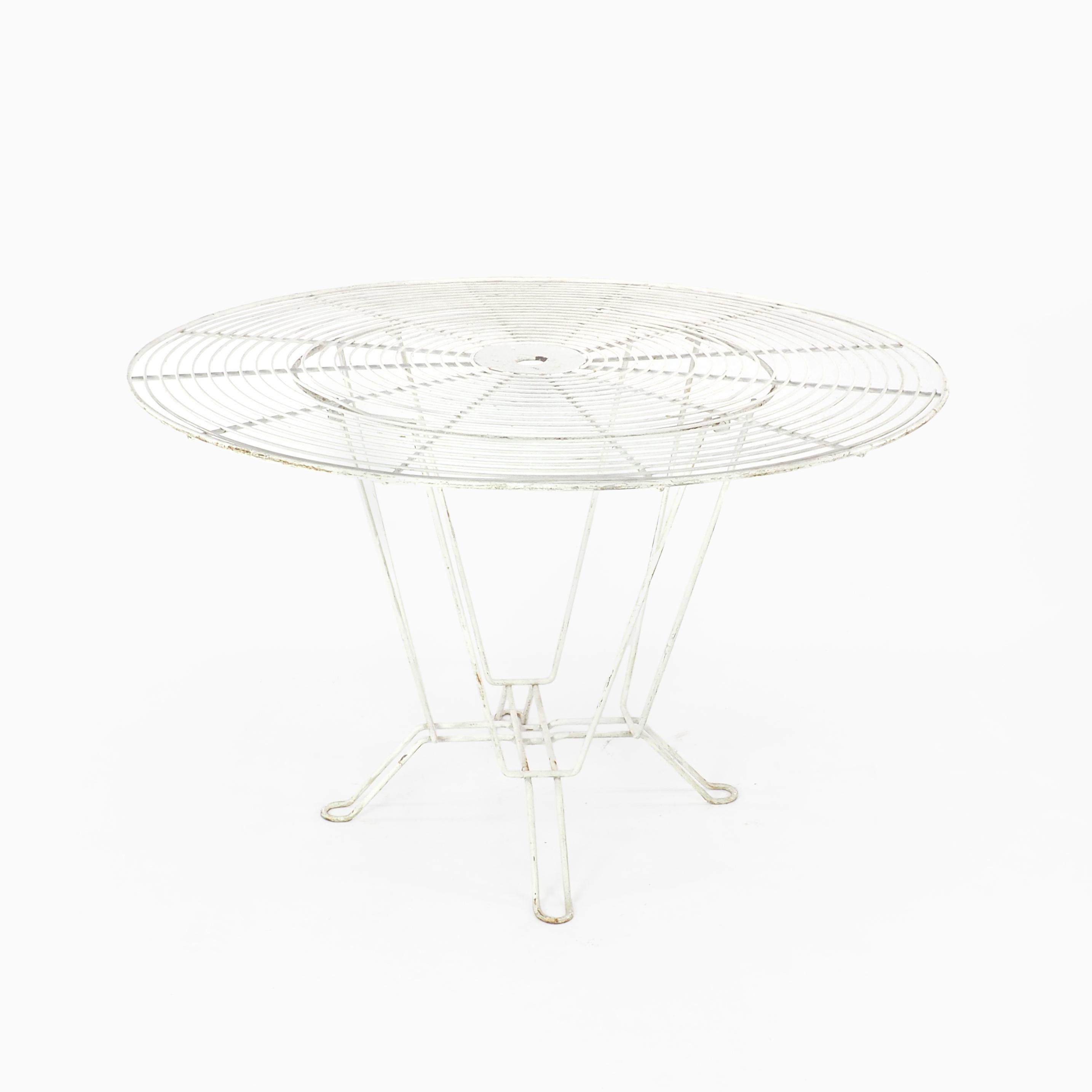 Stylish 1950s French garden table of futuristic concentric circular design with a central socket for a suitable sun shade. Perfect for poolside or patio, this table comes in original white with some rust marks consistent with age but can be dipped