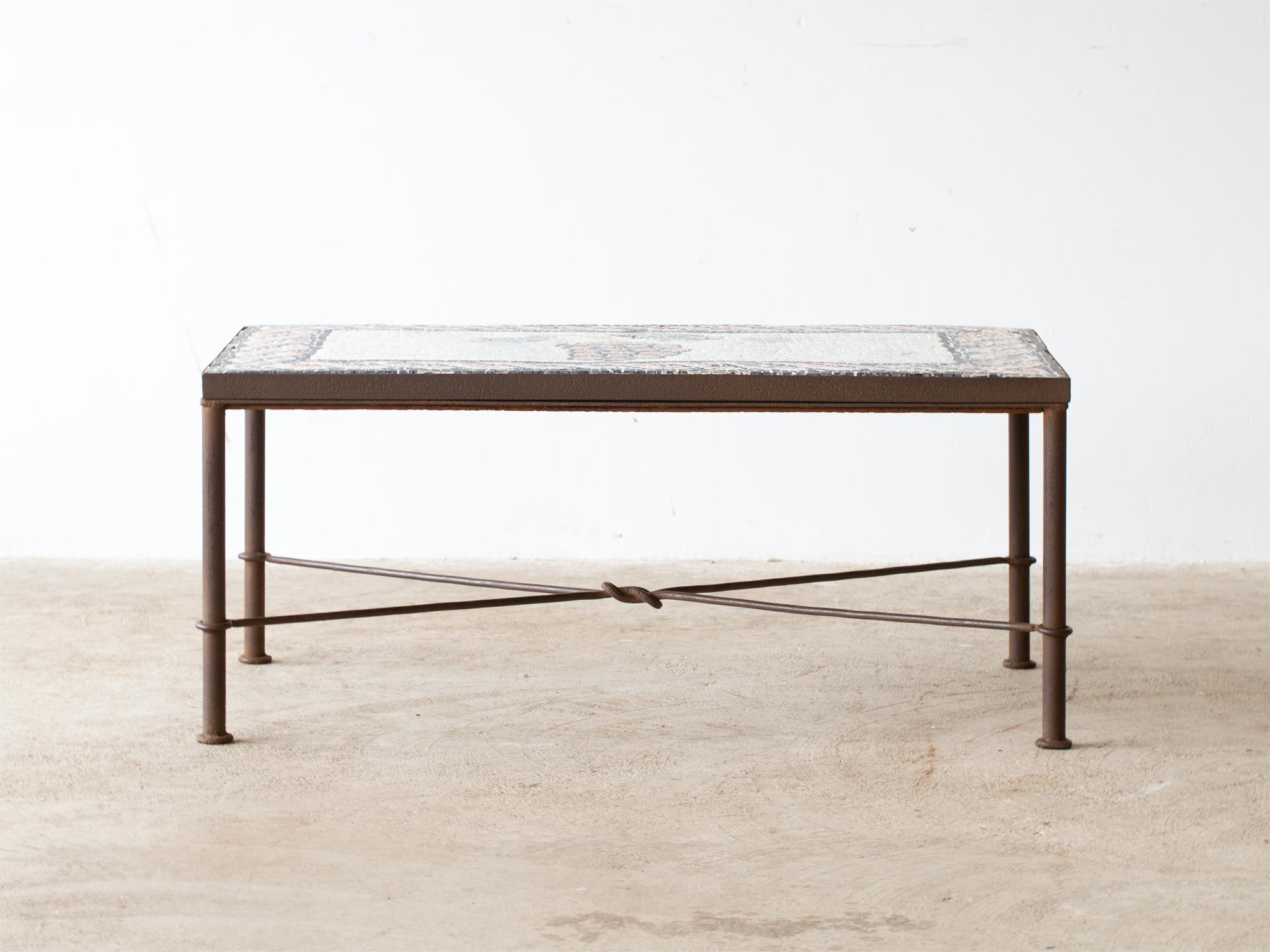 An artisanal mosaic coffee table raised on a forged iron base. French, c. 1960s. 

Stock ref. #2304

In good sturdy order, some losses to the mosaic. 

43.5 x 101 x 62 cm

17.1 x 39.8 x 24.4 “
