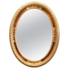 Specchio da parete ovale in legno dorato intagliato Napoleone III, metà secolo, francese