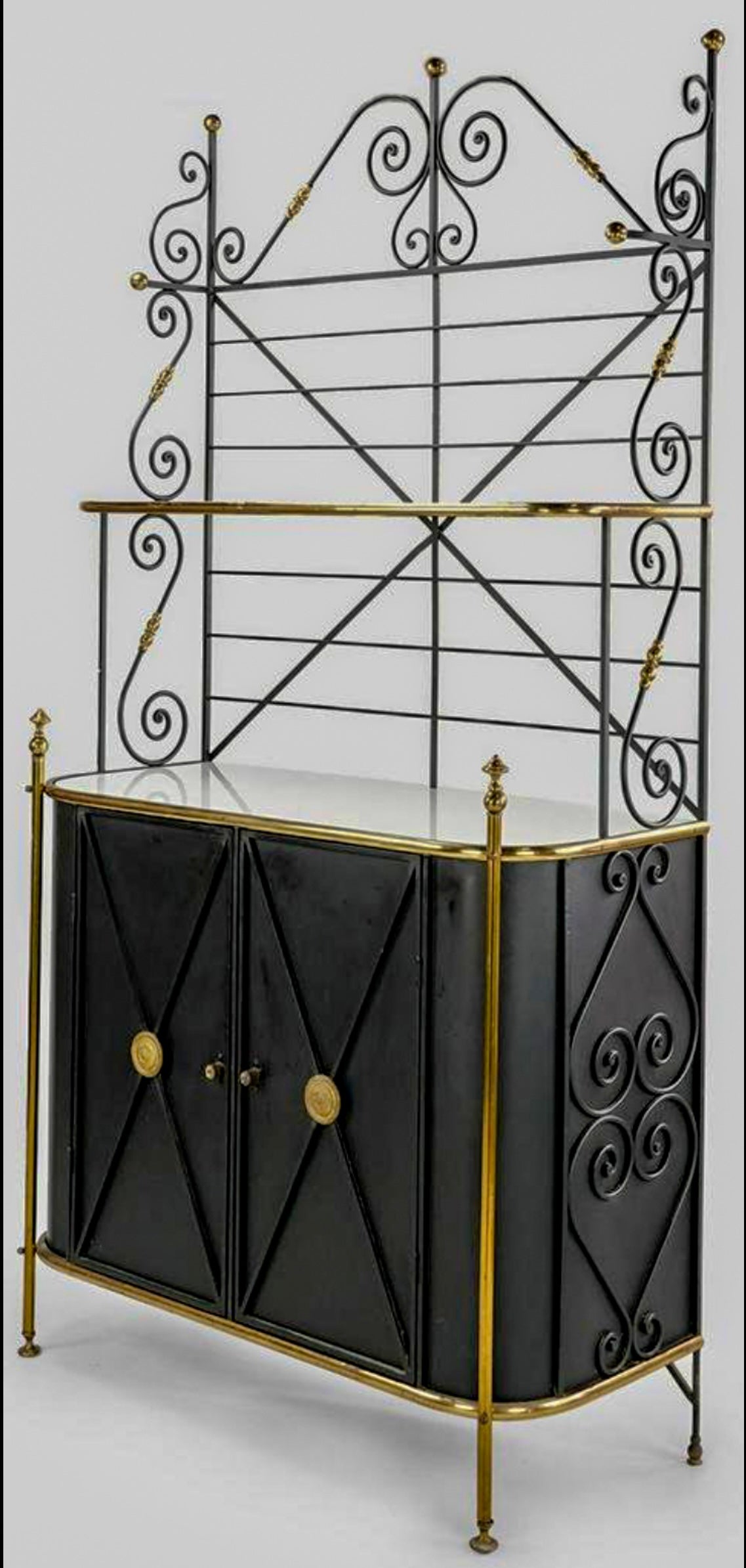 This is an exceptional French baker’s rack with original milk glass shelves. It would make a killer bar too. A versatile piece to be sure. It is a combination of aluminum, iron, and brass, and it is very heavy construction. It includes the key for