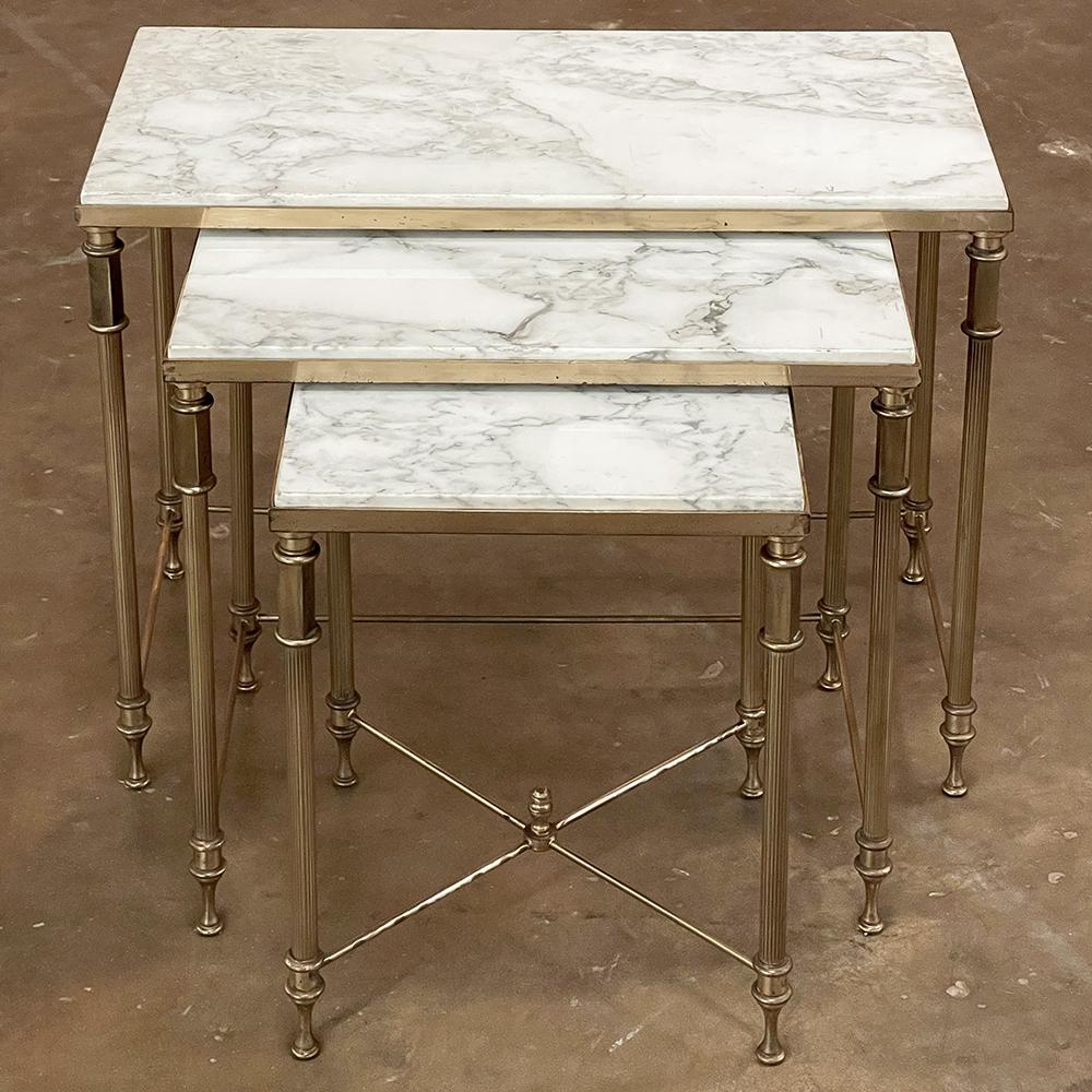 midcentury French neoclassical brass nesting tables with marble tops are the perfect answer for the efficient interior! handcrafted from brass, each features four legs that combine turnings, square tubing, and fluted columns connected by brass rods