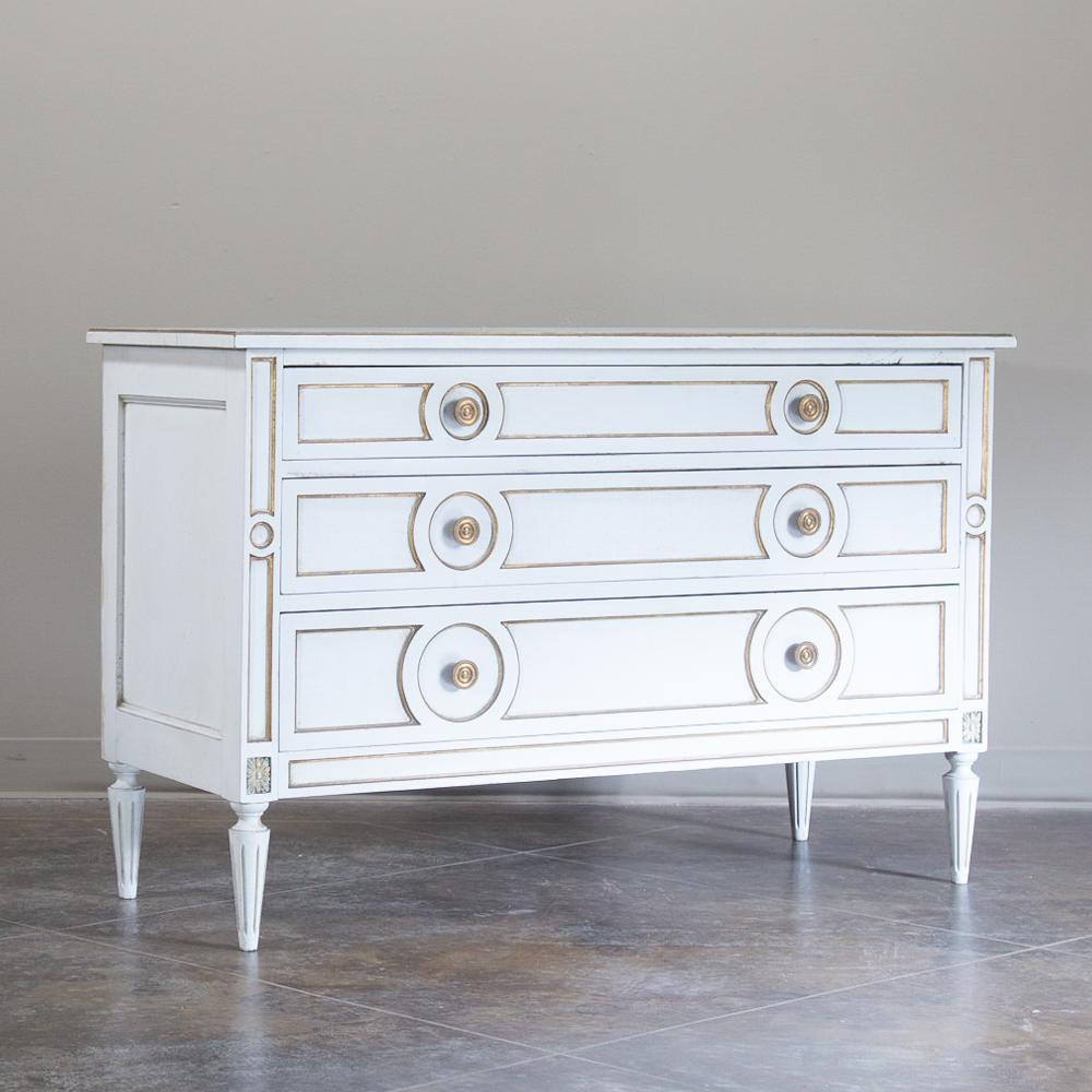Midcentury French neoclassical painted commode is a study in both style and efficiency! Tailored, classical lines are enhanced by the patinaed painted finish, with three spacious drawers fitted with brass knobs for a nice touch. Tasteful gold
