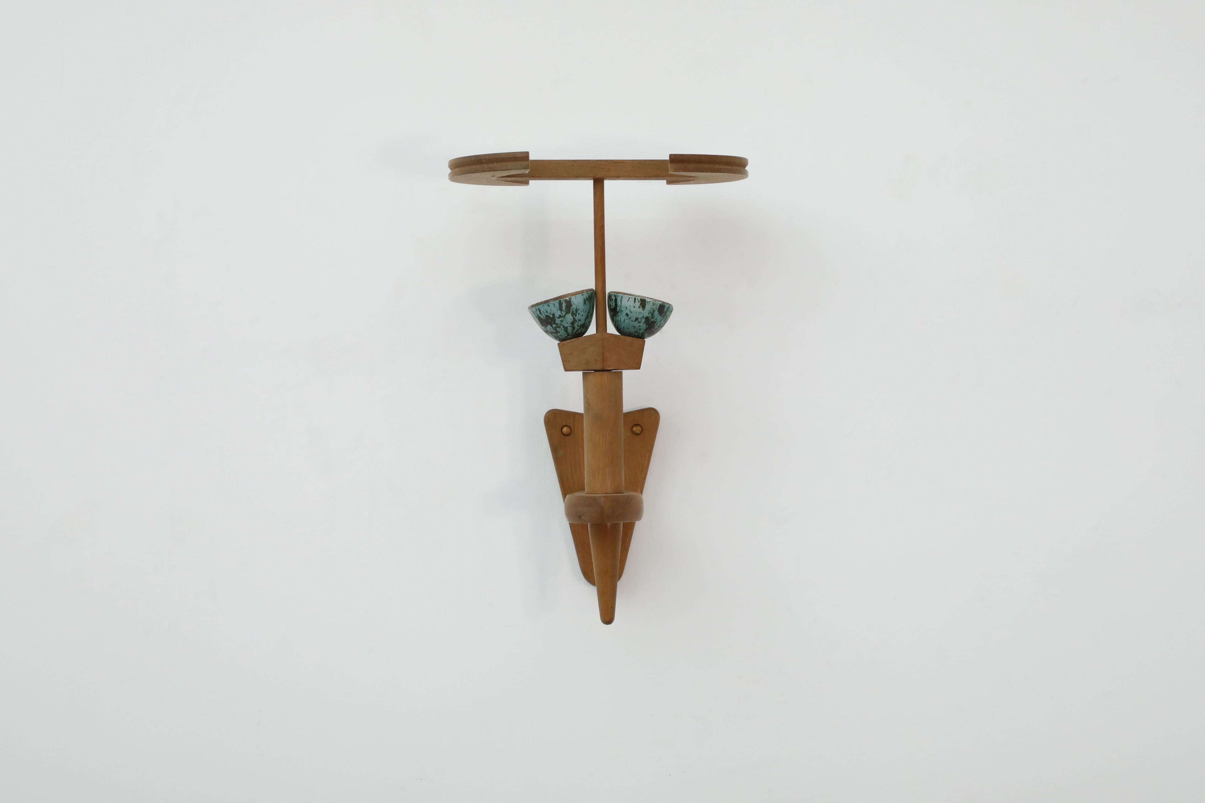 Mid-Century oak and ceramic wall sconce by Guillerme et Chambron for Votre Maison. Unique French oak wall lamp that sits like a torch in it's holder. It has sage ceramic cups that hold the original bayonet sockets and a canopy-like oak frame for a