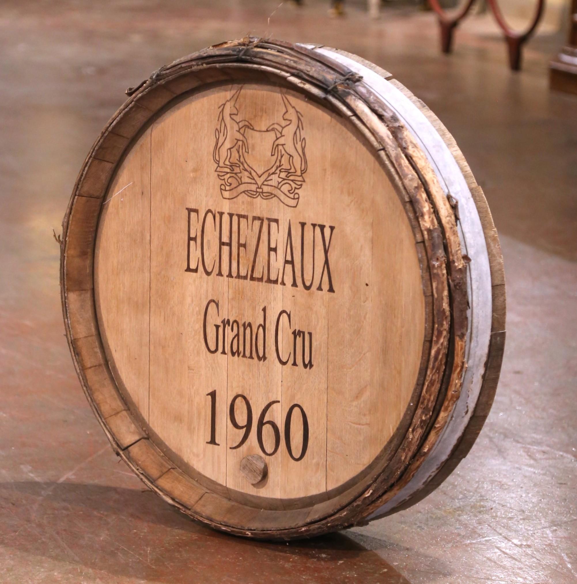 Add a touch of Burgundy charm to your wine cellar with this large vintage wine barrel. Crafted in the renowned wine region of Burgundy, France and dated 1960, this decorative piece features the top of an authentic oak barrel, secured with its